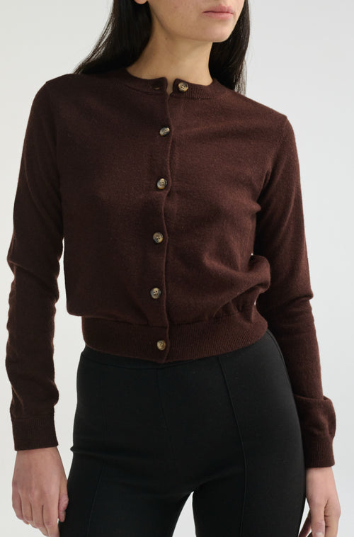 Brown button-up shirt worn by a person on a white background