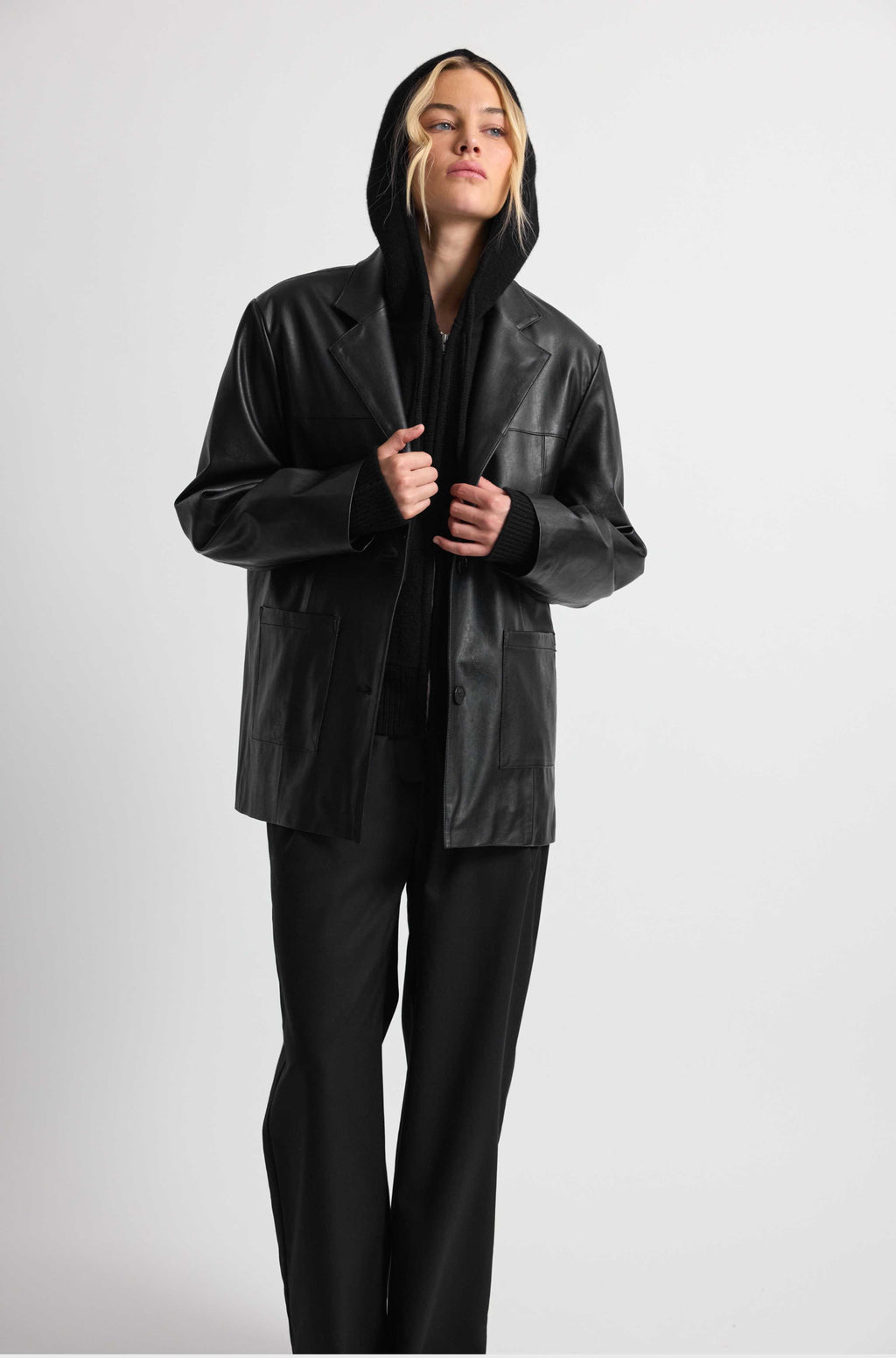 Person wearing a black raincoat on a white background