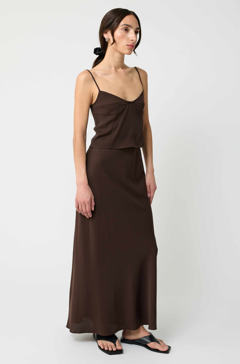 Woman wearing a brown dress on a white background