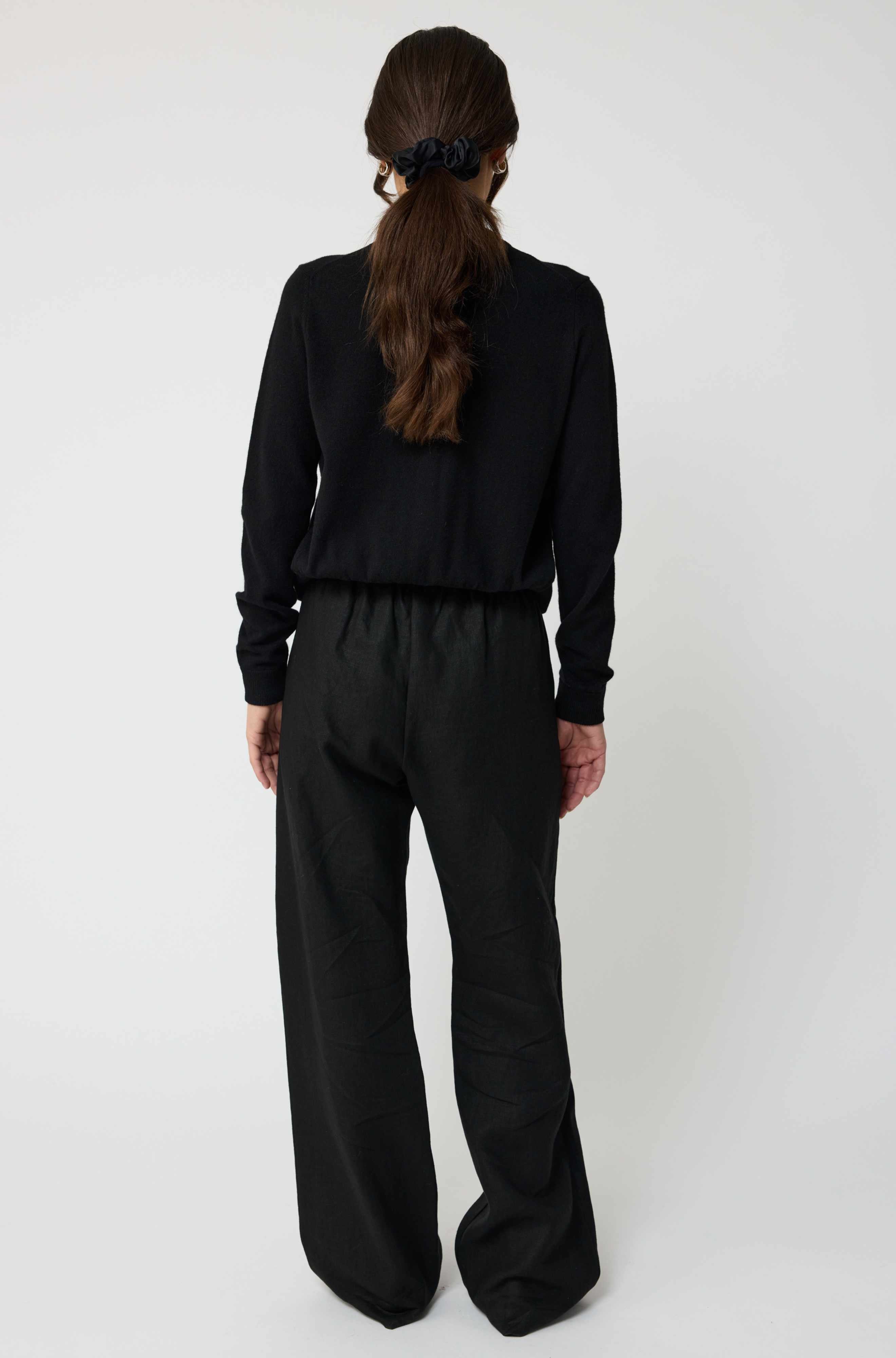 Person wearing a black outfit on a white background