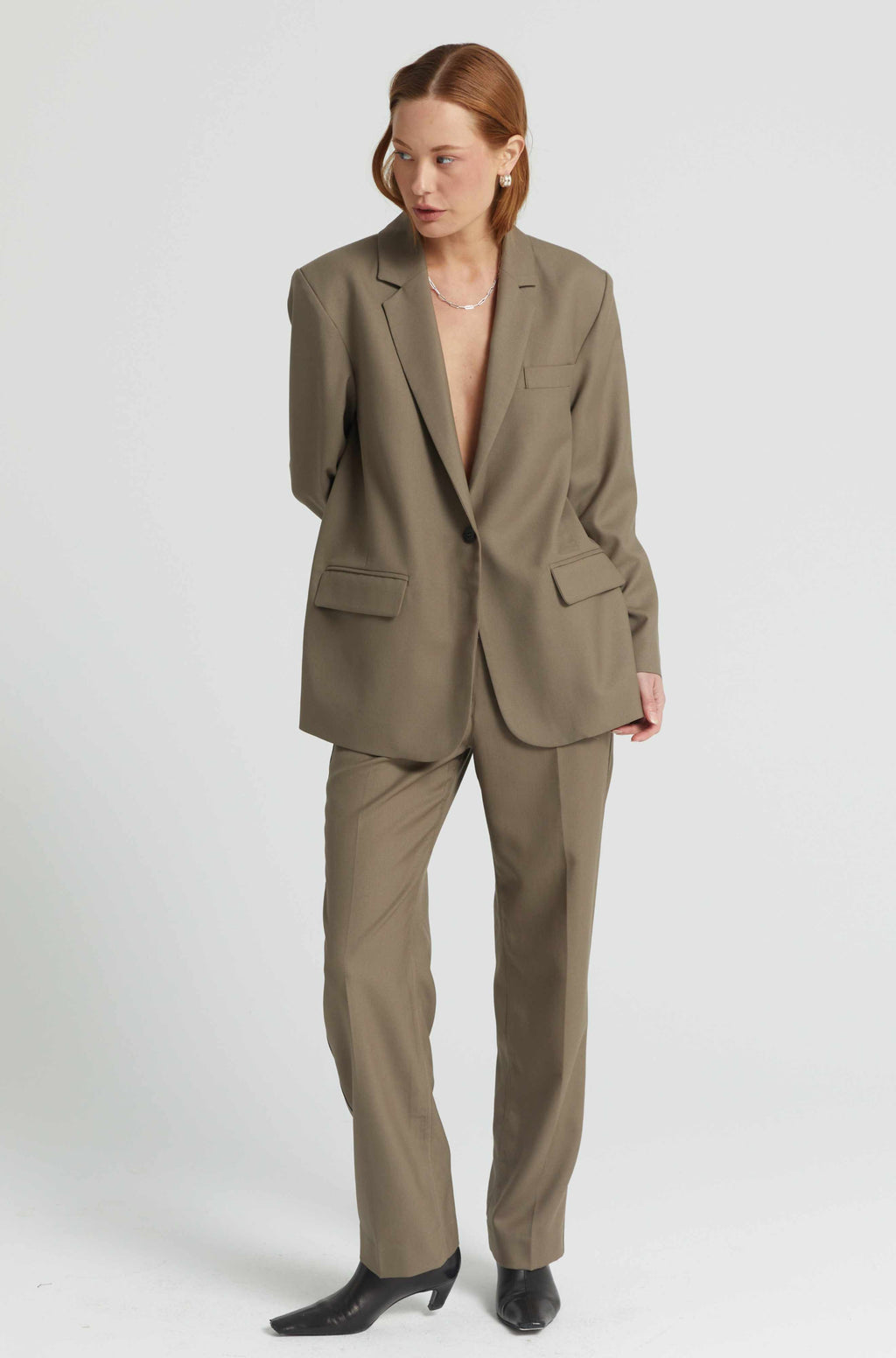 Woman wearing a beige suit on a white background