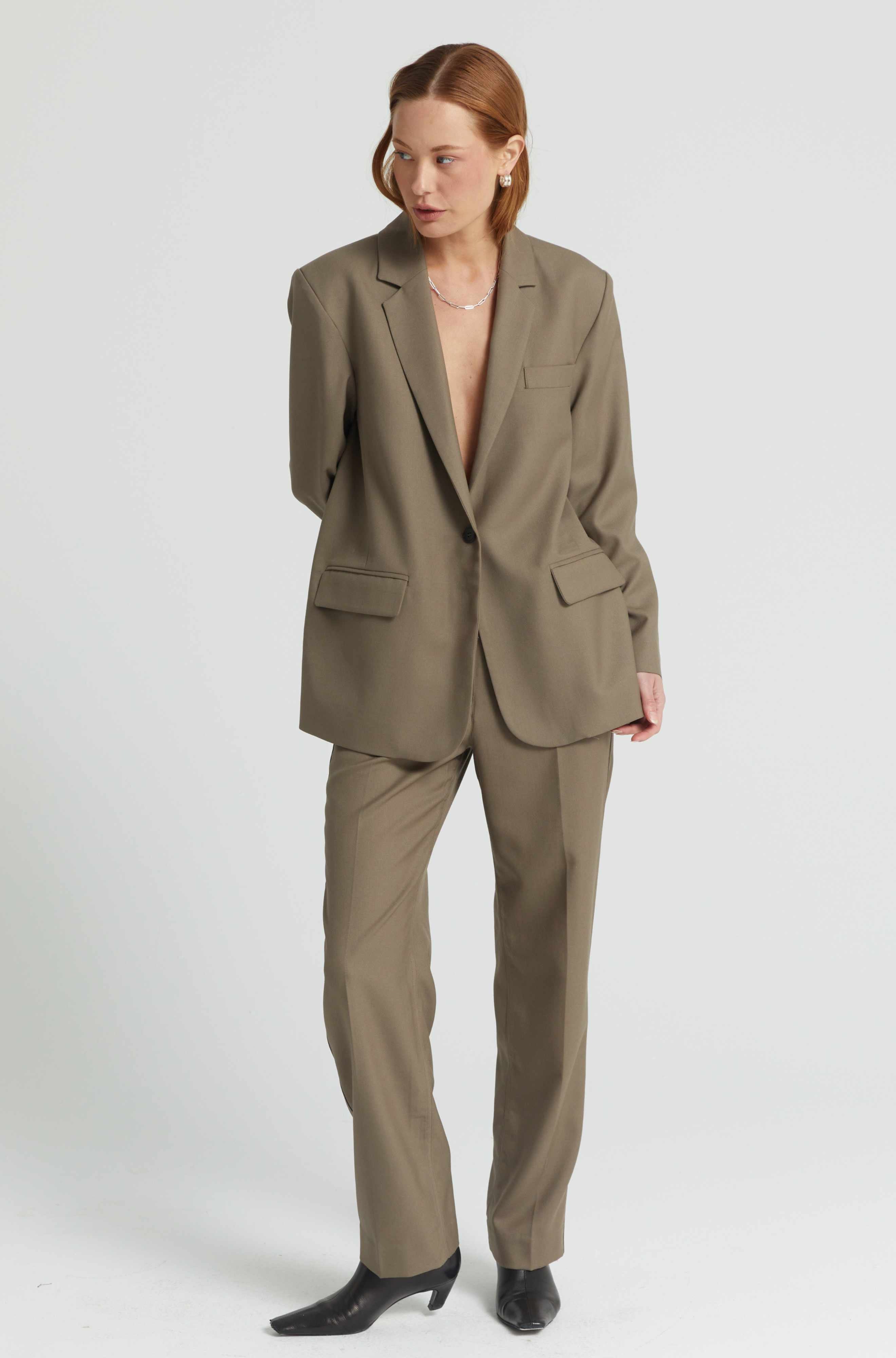 Woman wearing a beige suit on a white background