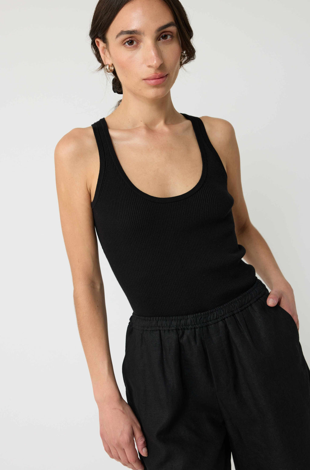 Woman wearing a black tank top and shorts