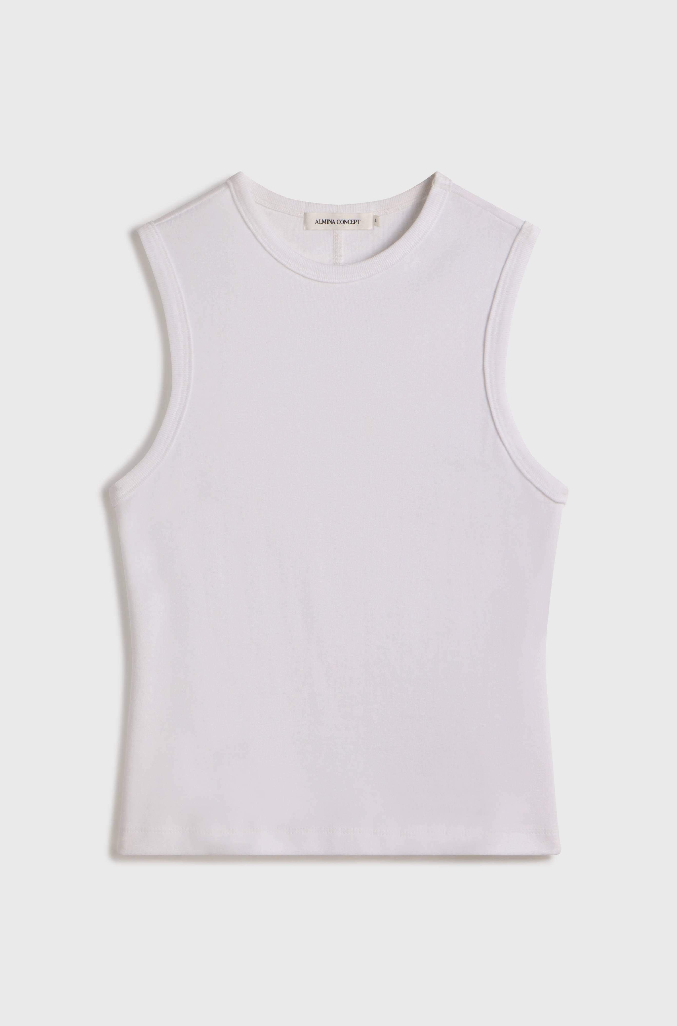 White sleeveless top on a light beige background