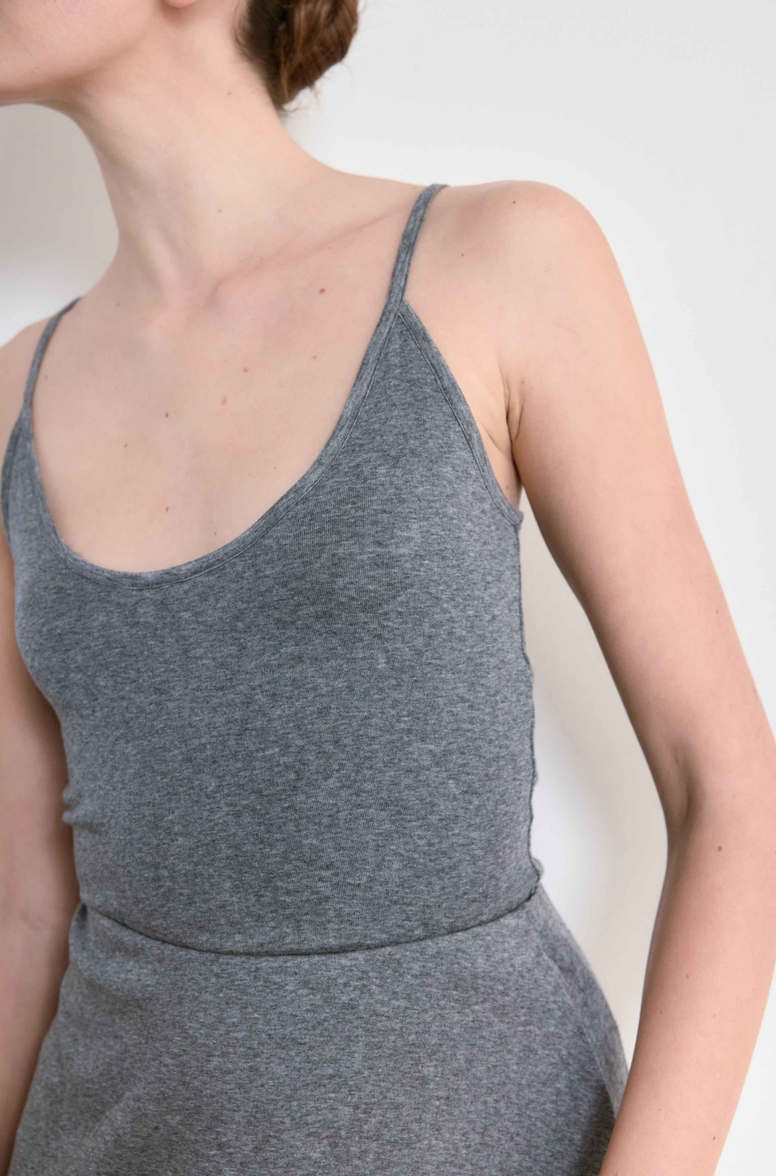 Gray tank top worn by a person on a white background