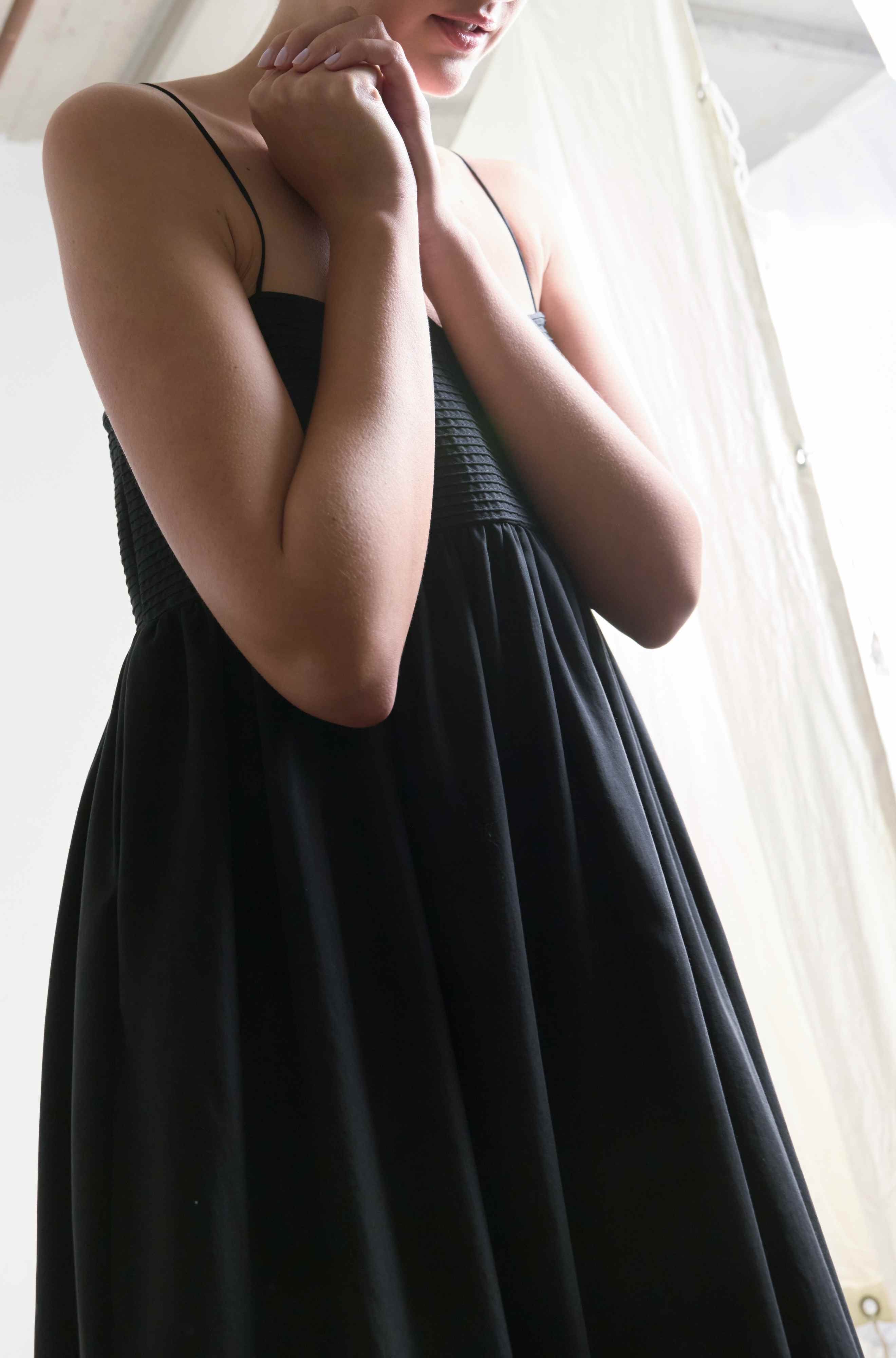 Woman wearing a black dress with a blurred background