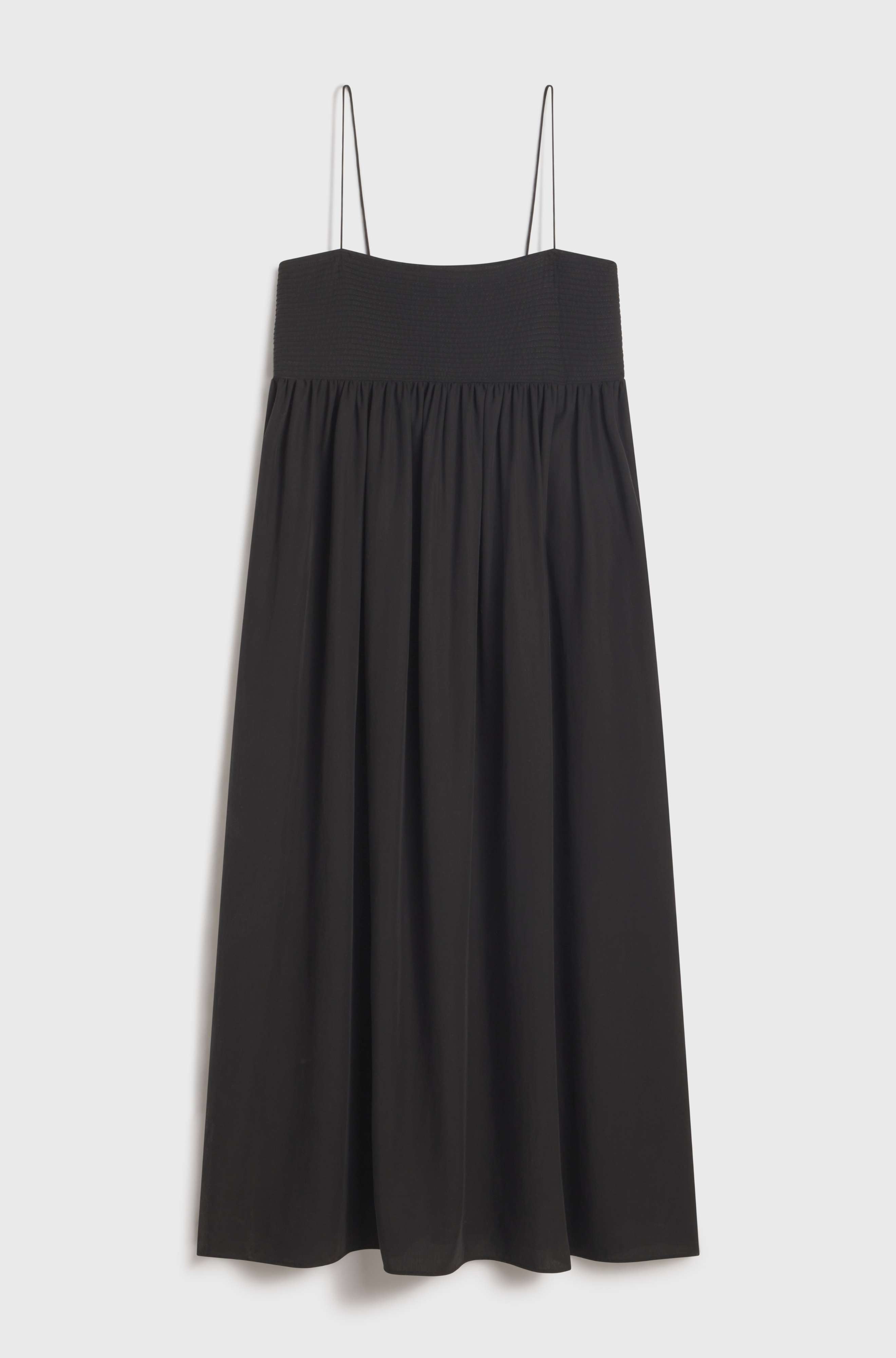 Black dress with thin straps on a light gray background