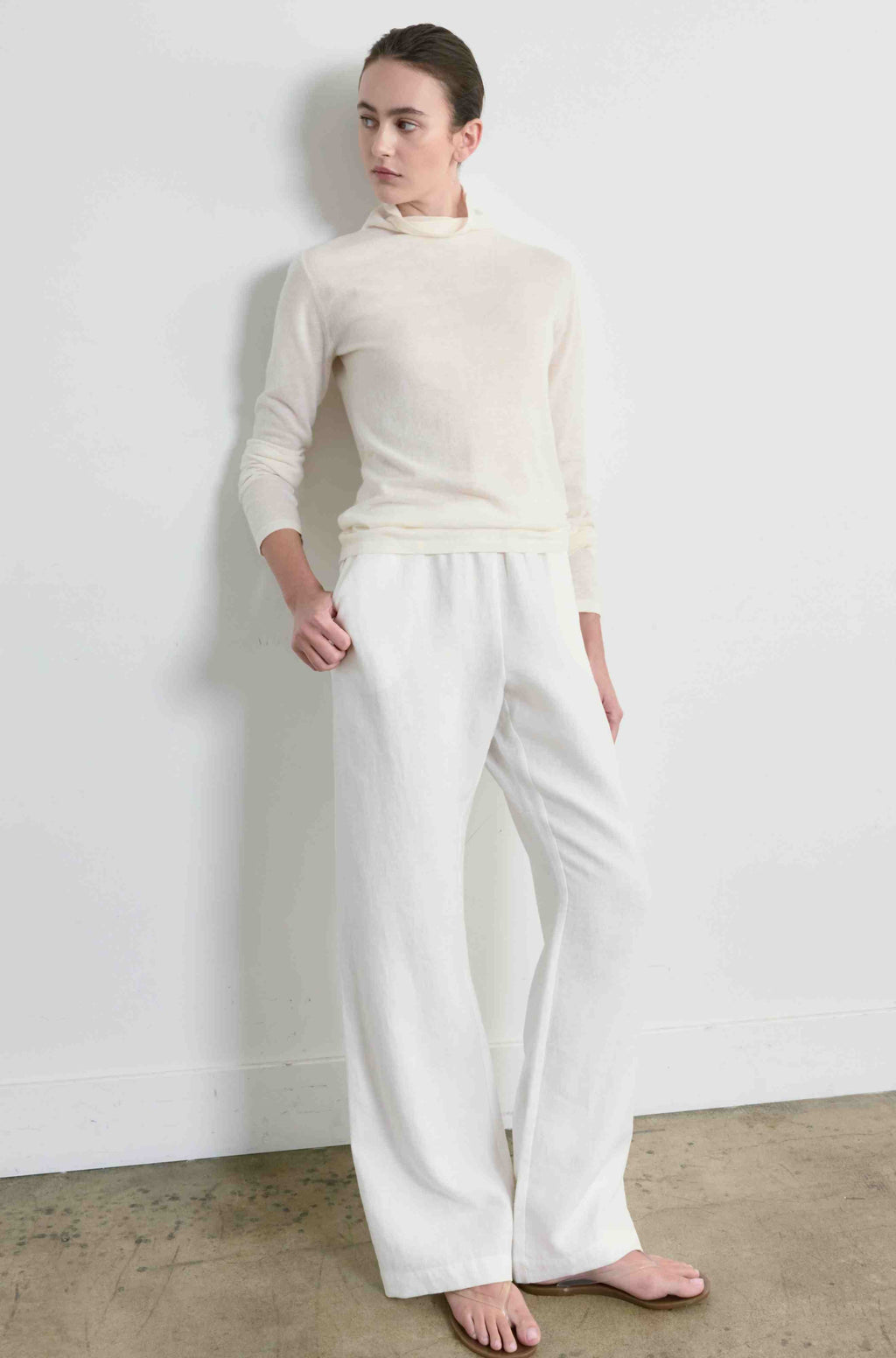 Person wearing a white outfit against a plain background