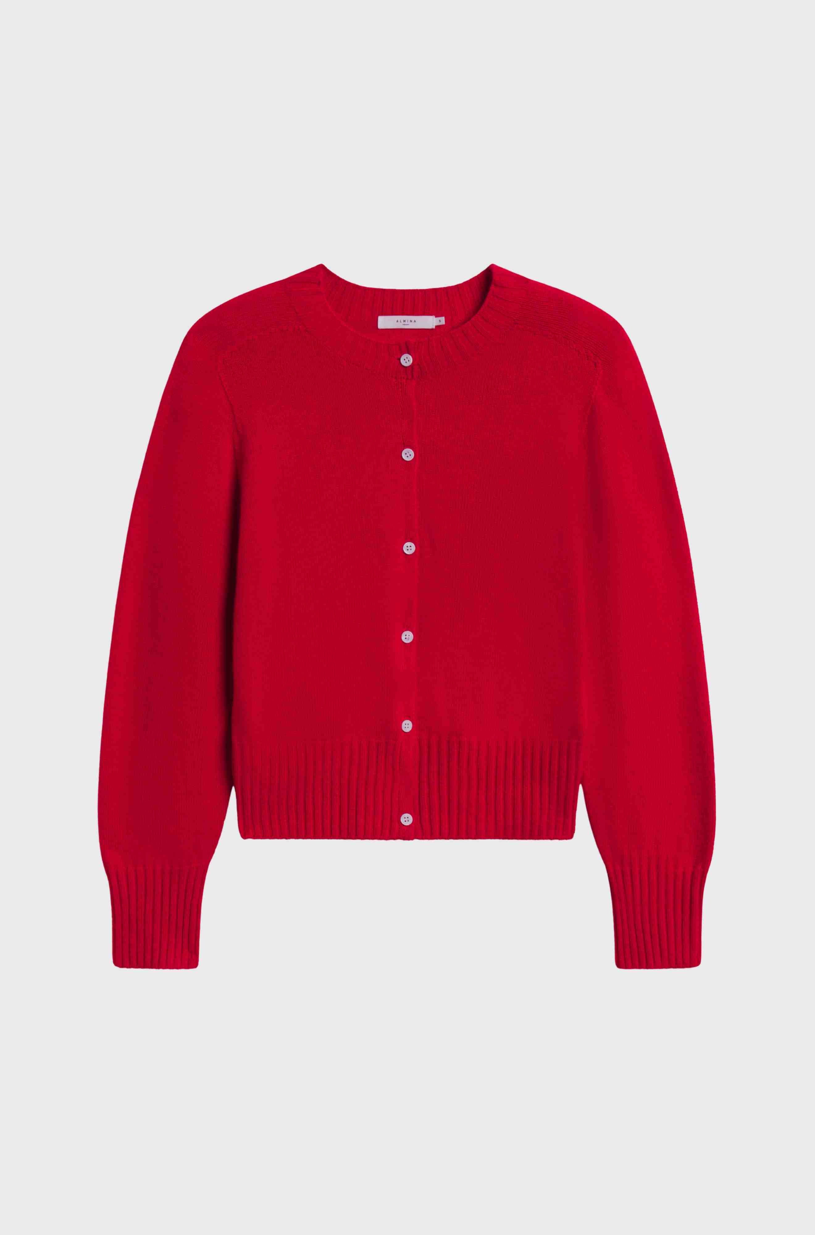 Red cardigan with white buttons on a light gray background