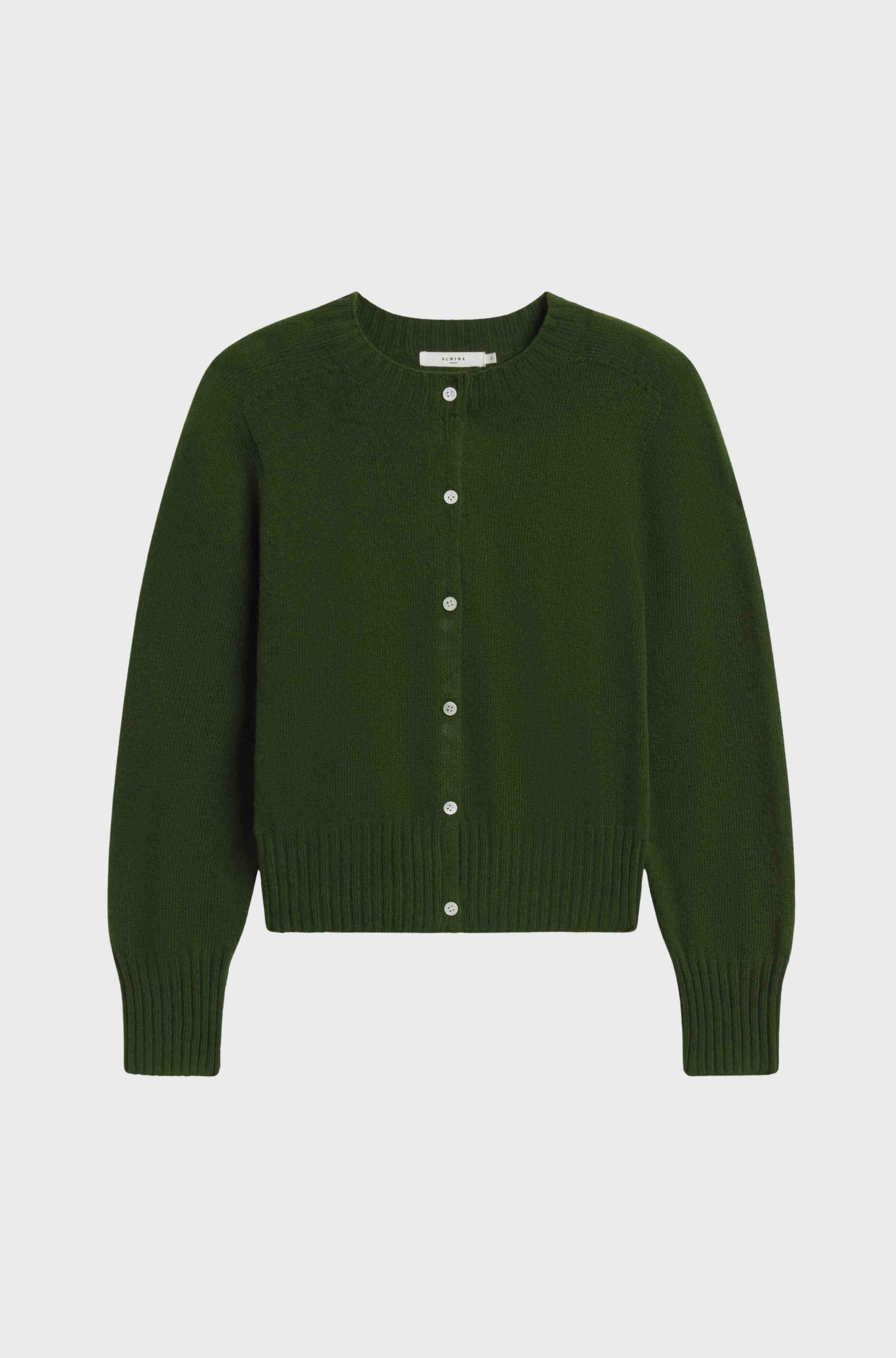 Green cardigan with white buttons on a light gray background