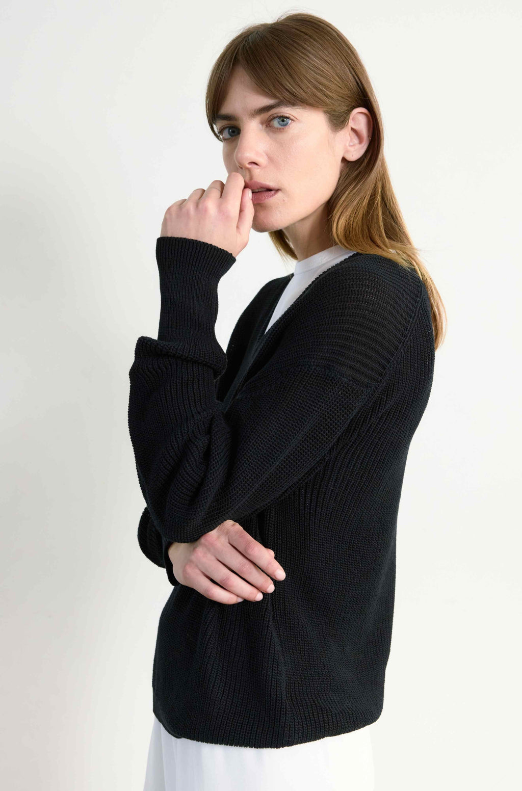 Woman wearing a black sweater on a white background