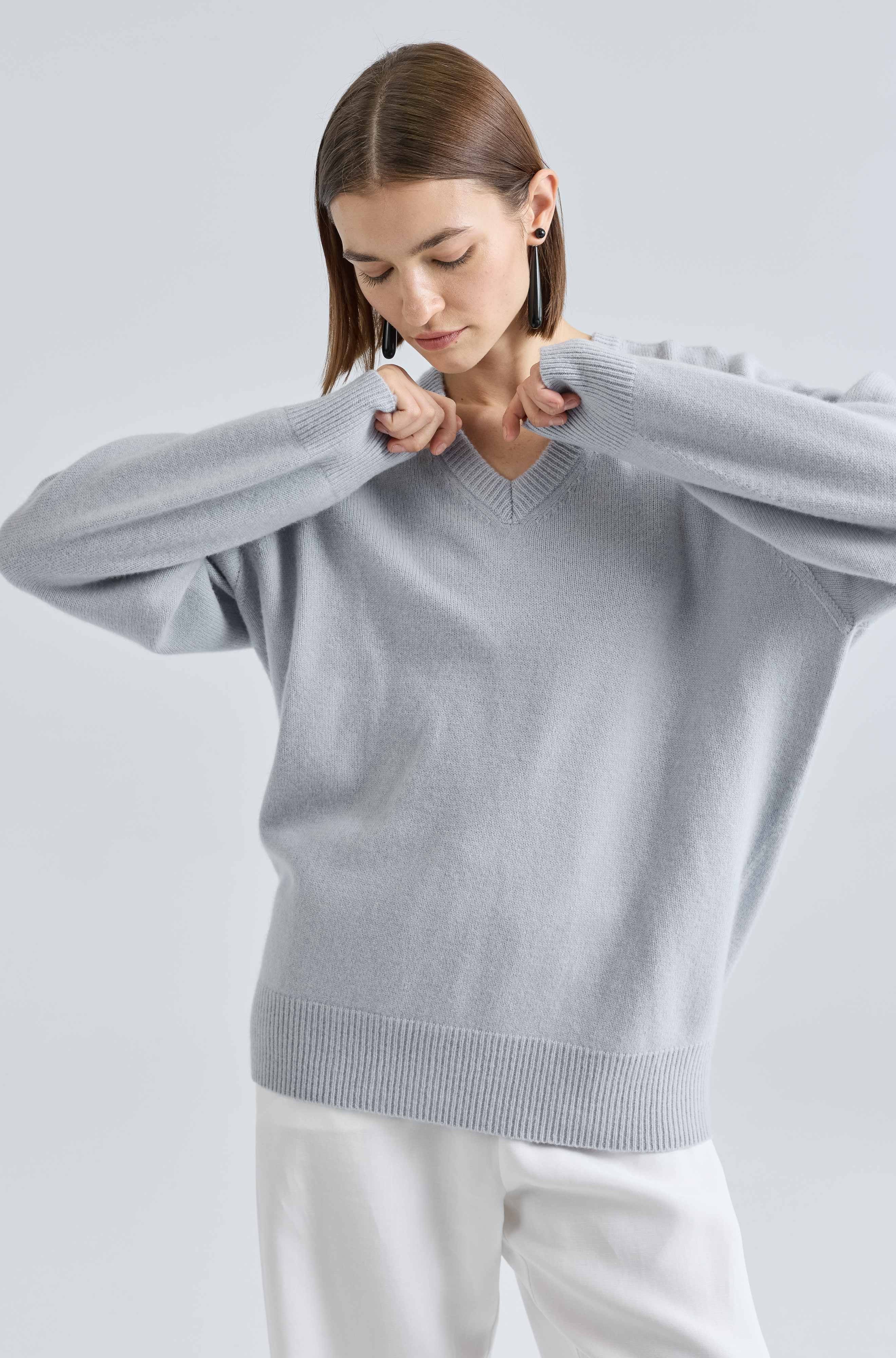 Woman wearing a light blue sweater against a light gray background