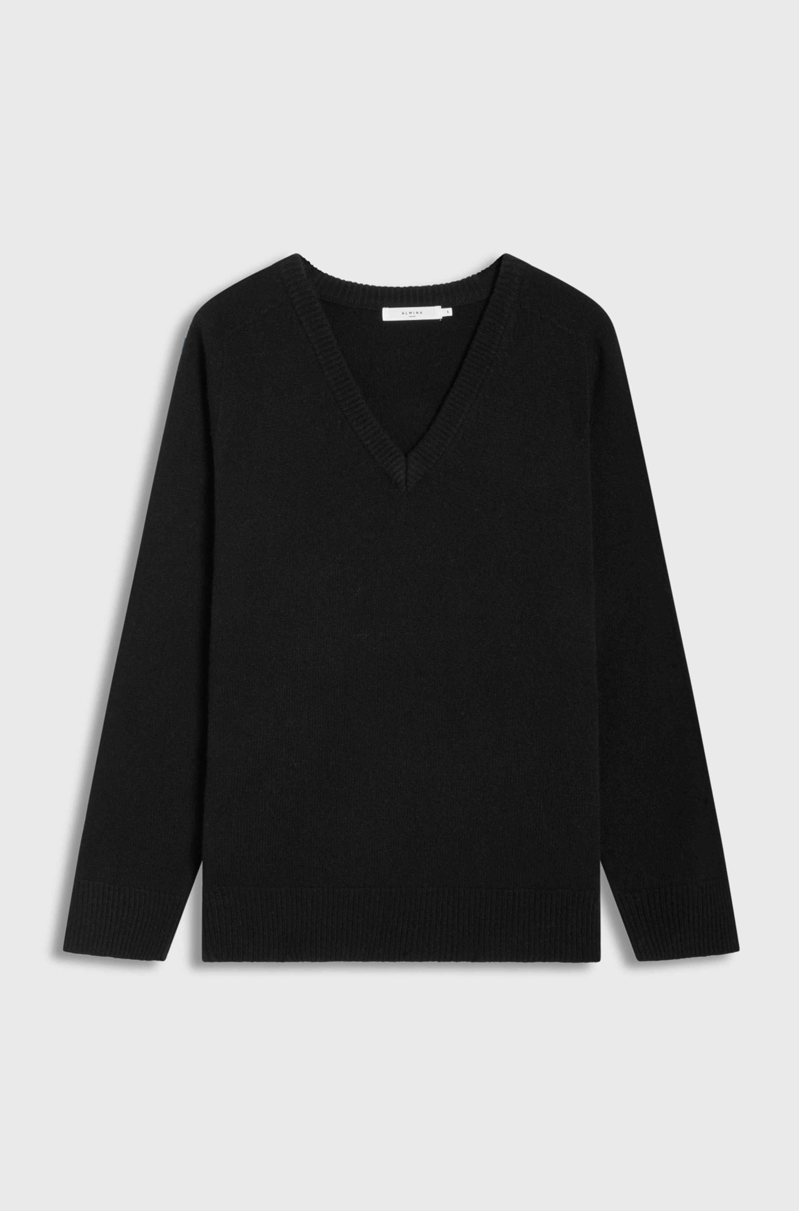 Black sweater on a light gray background
