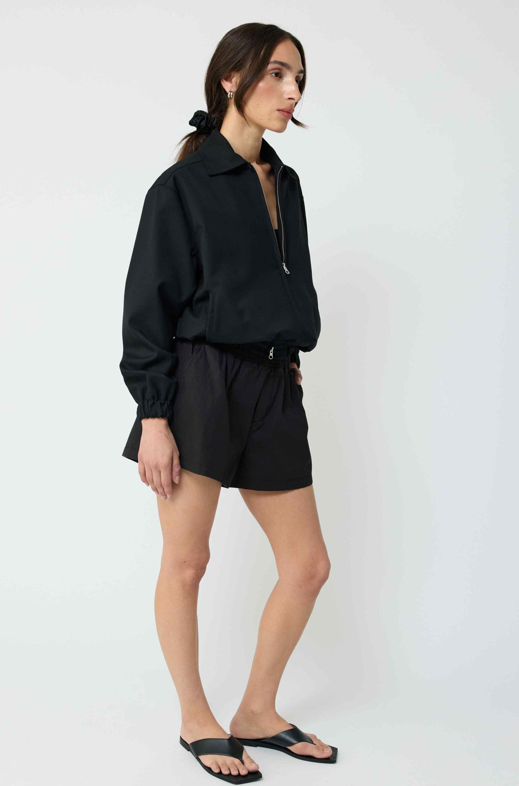 Woman wearing a black outfit on a white background