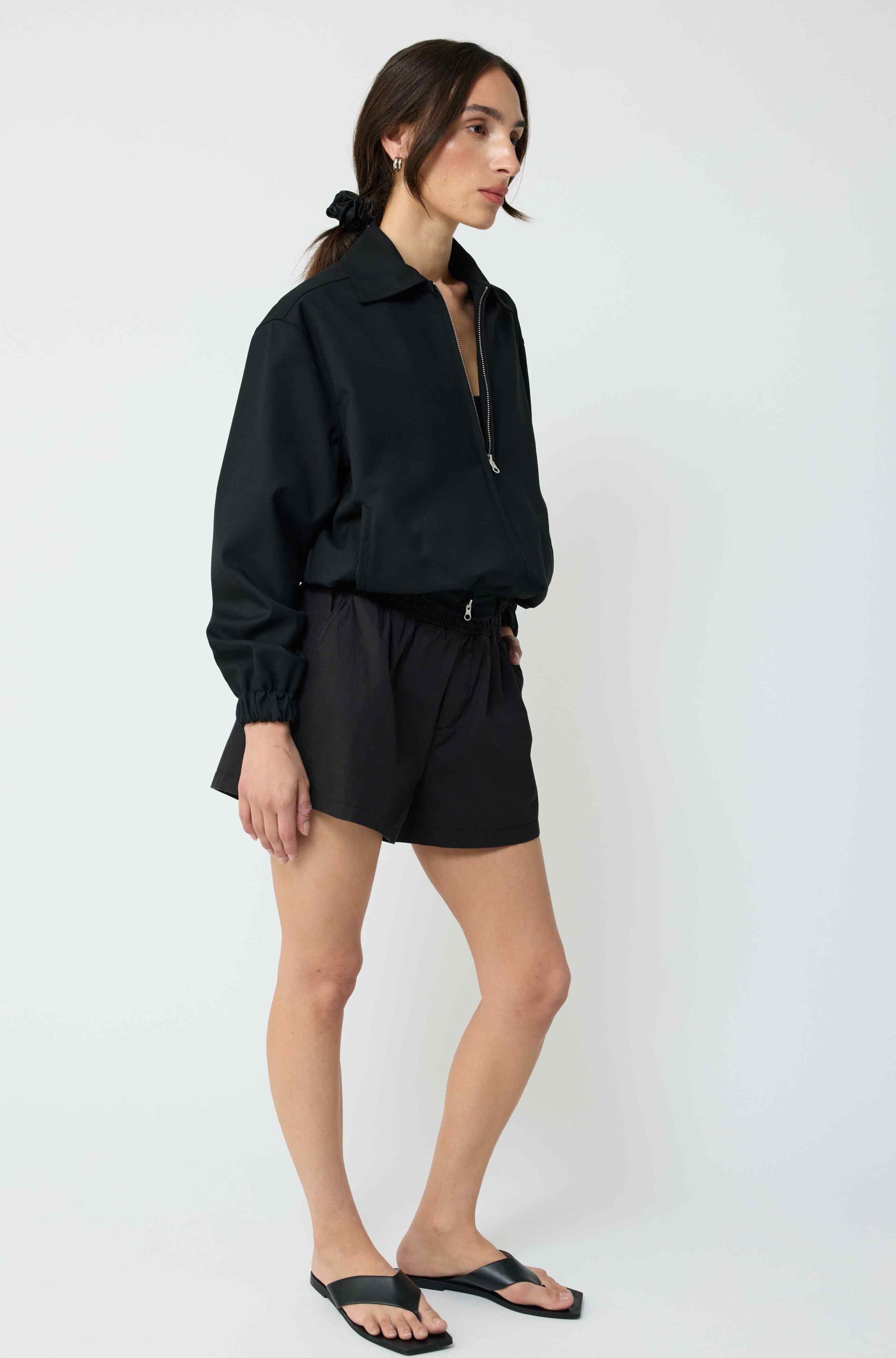 Woman wearing a black outfit on a white background