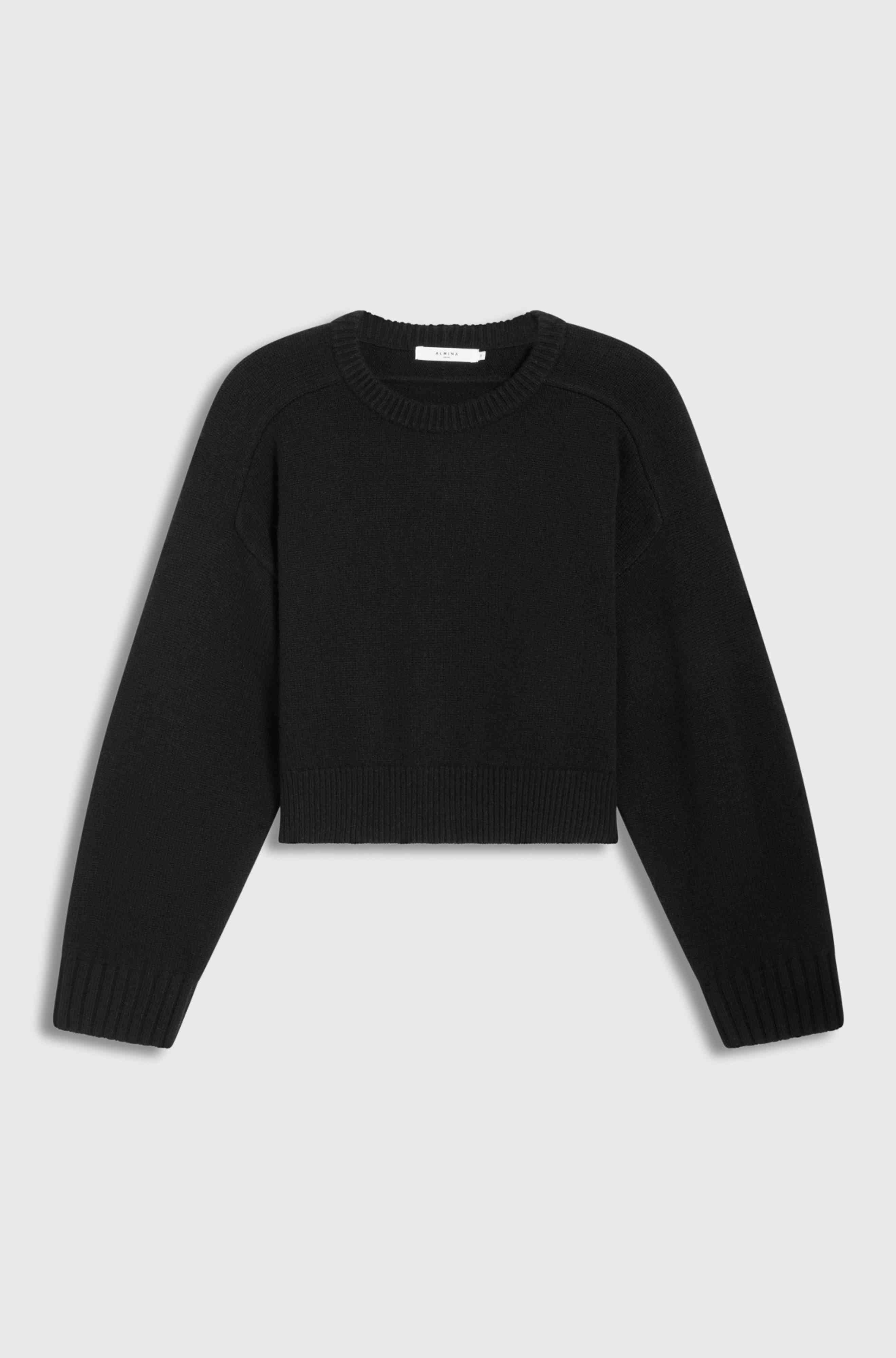 Black sweater on a light gray background