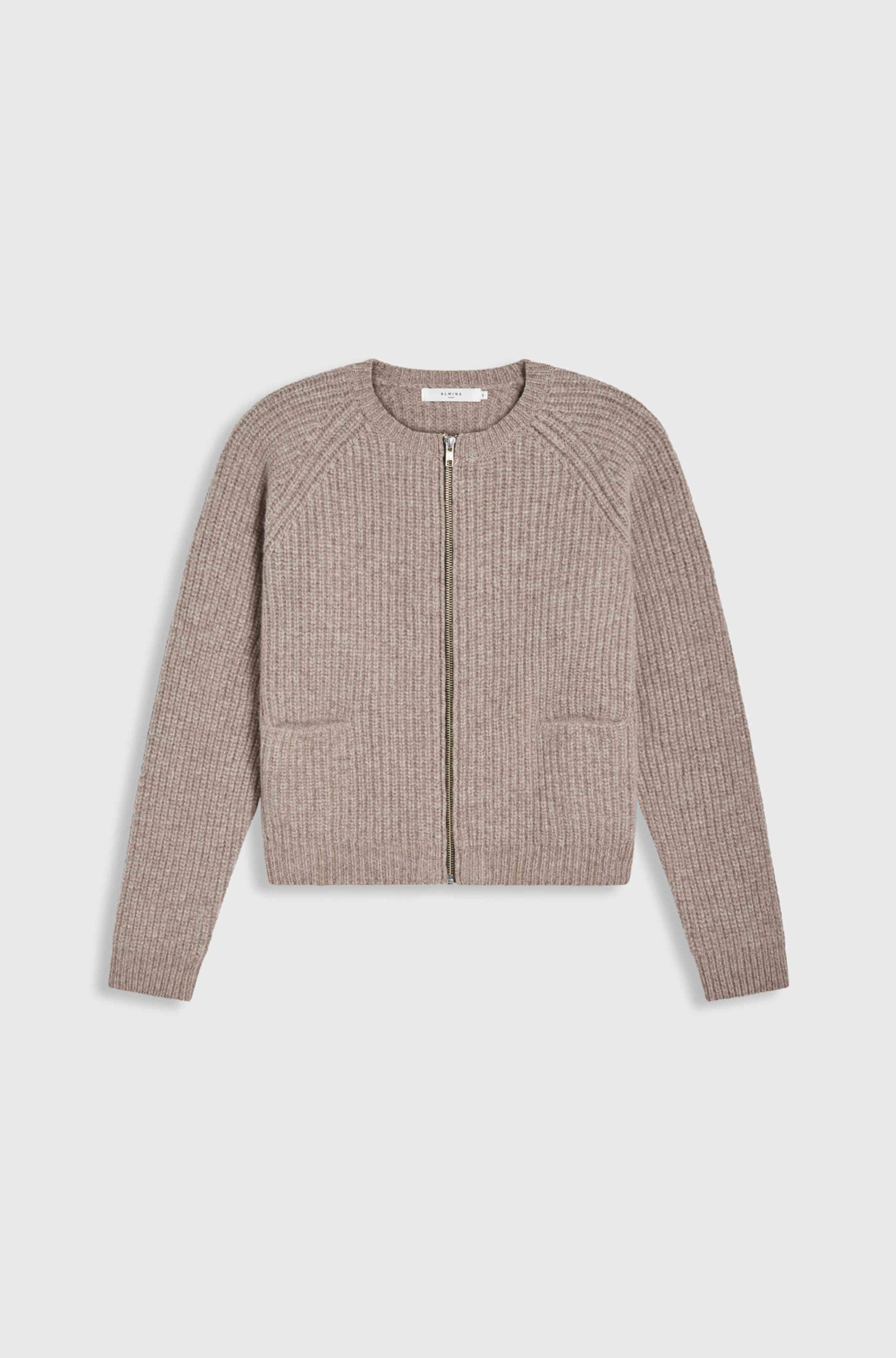 Light brown ribbed zip-up sweater on a light gray background