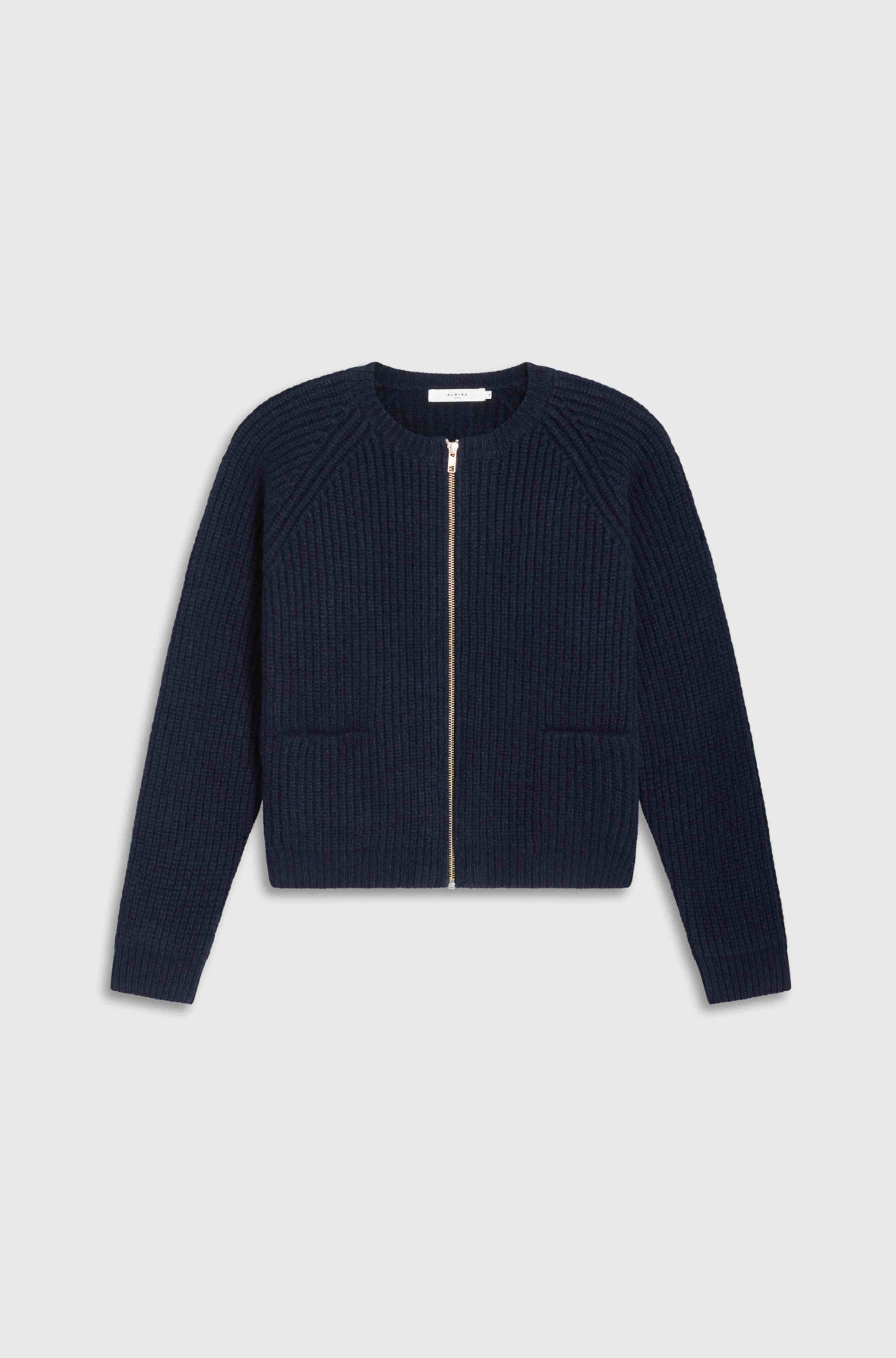Navy blue ribbed zip-up sweater on a light gray background