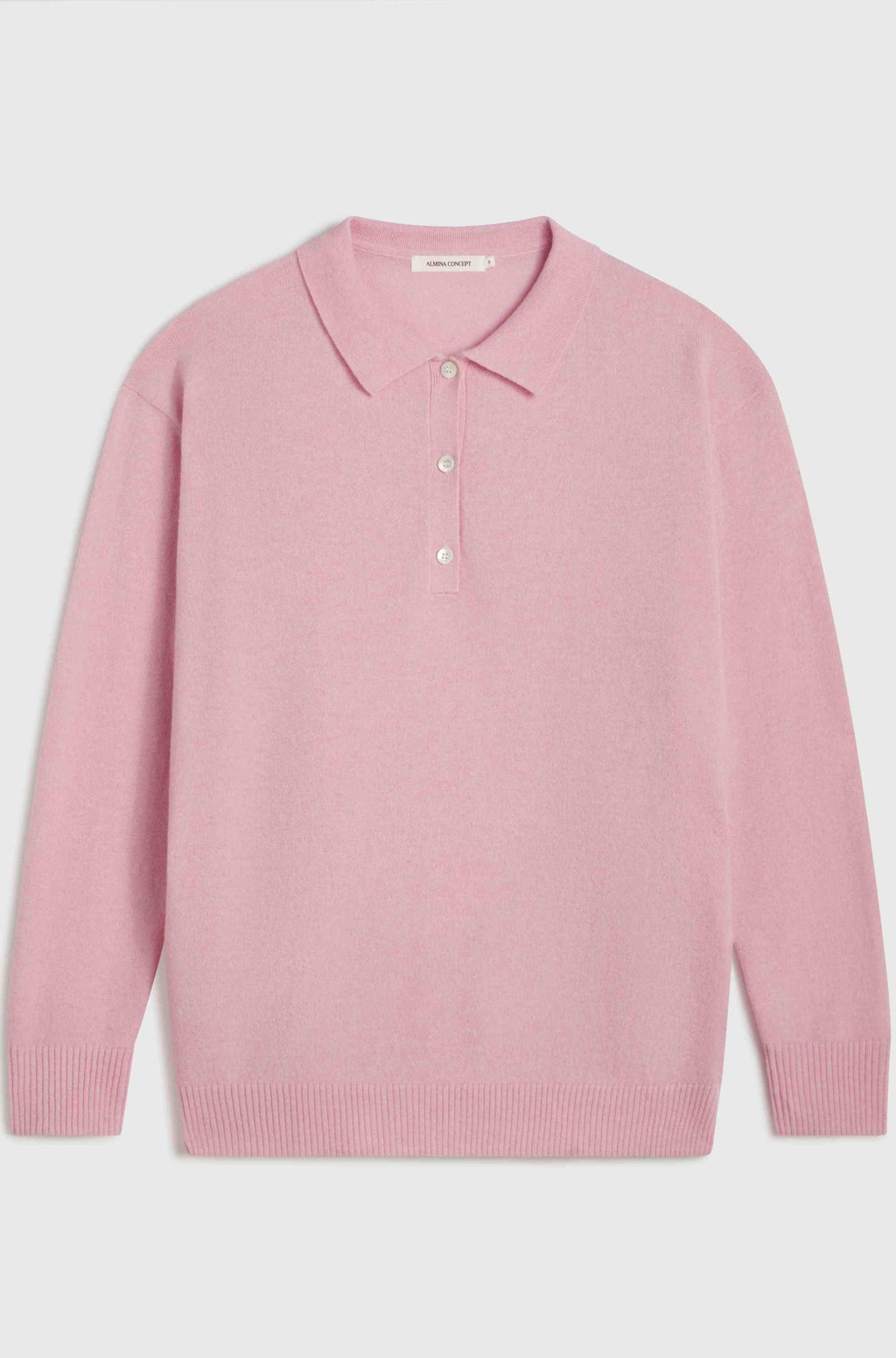 Pink polo sweater with a collar on a light gray background