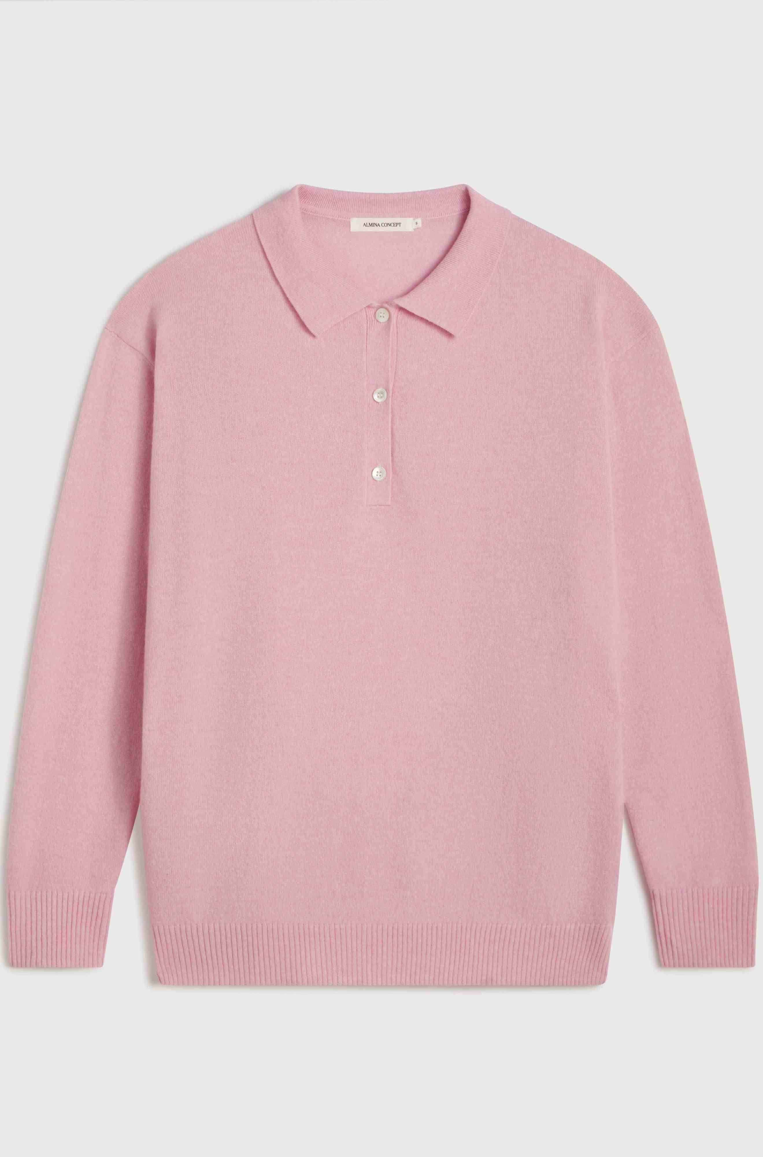 Pink polo sweater with a collar on a light gray background