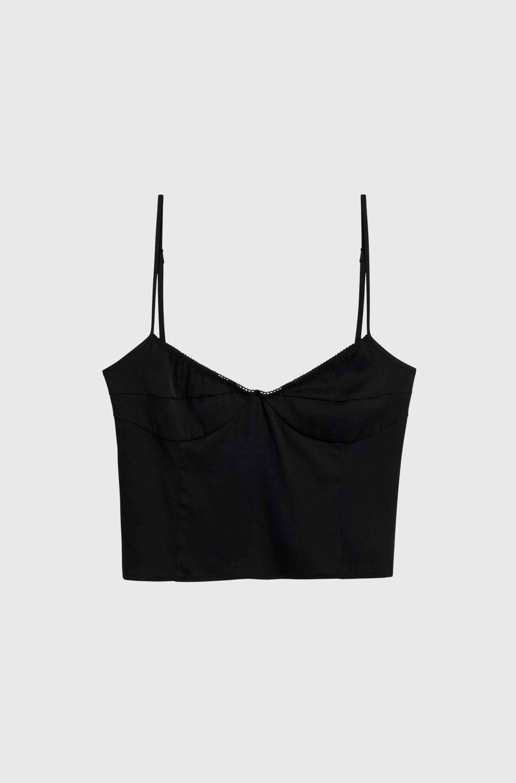 Black silk top with thin straps on a light gray background