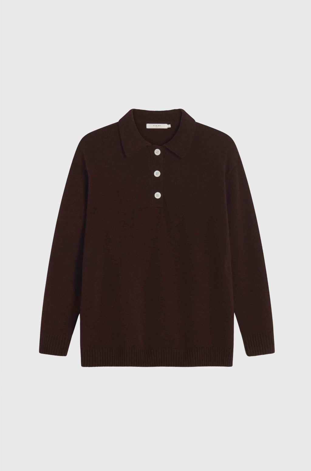 Brown sweater with white buttons on a light gray background