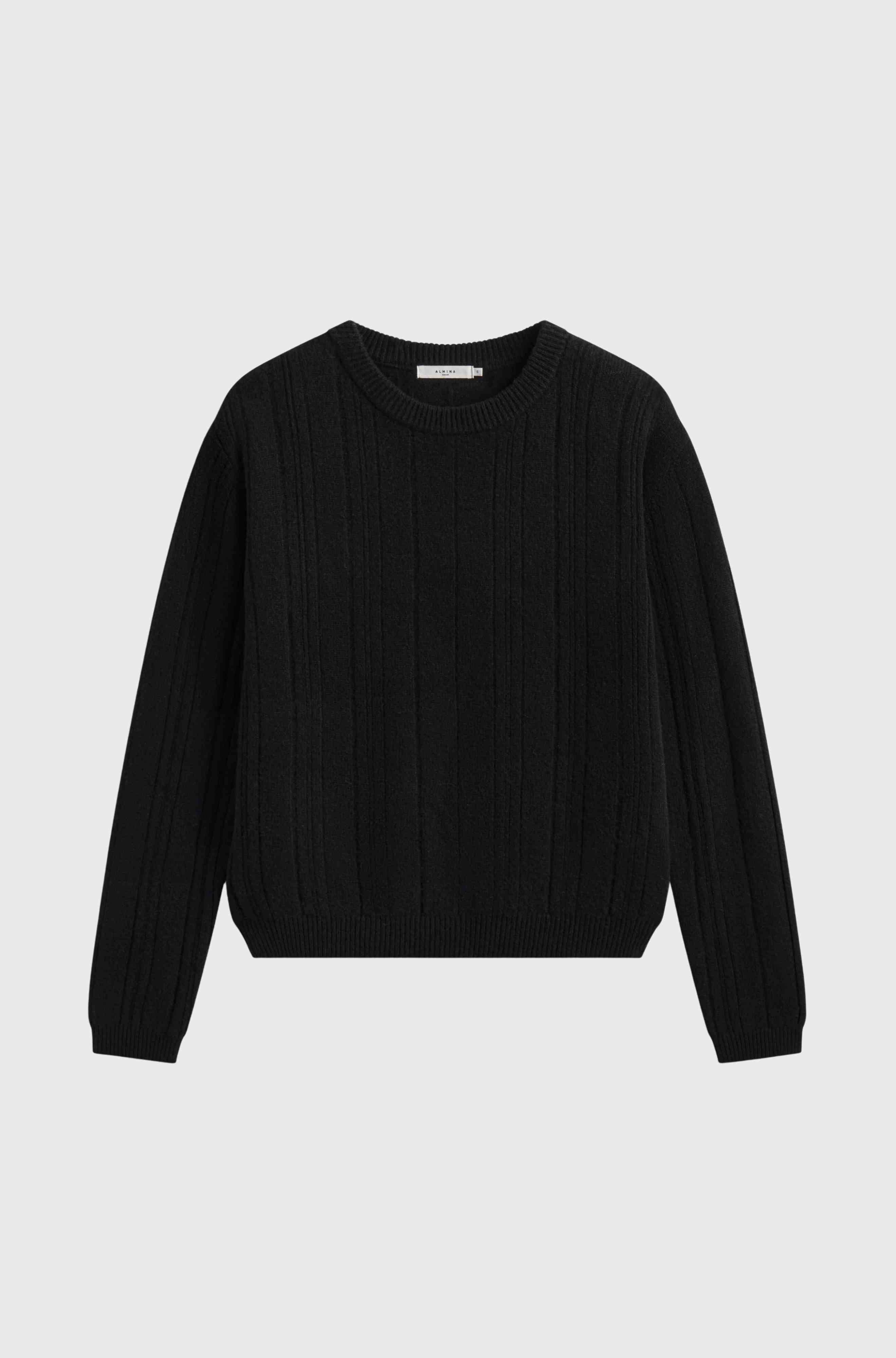 Black sweater on a light gray background