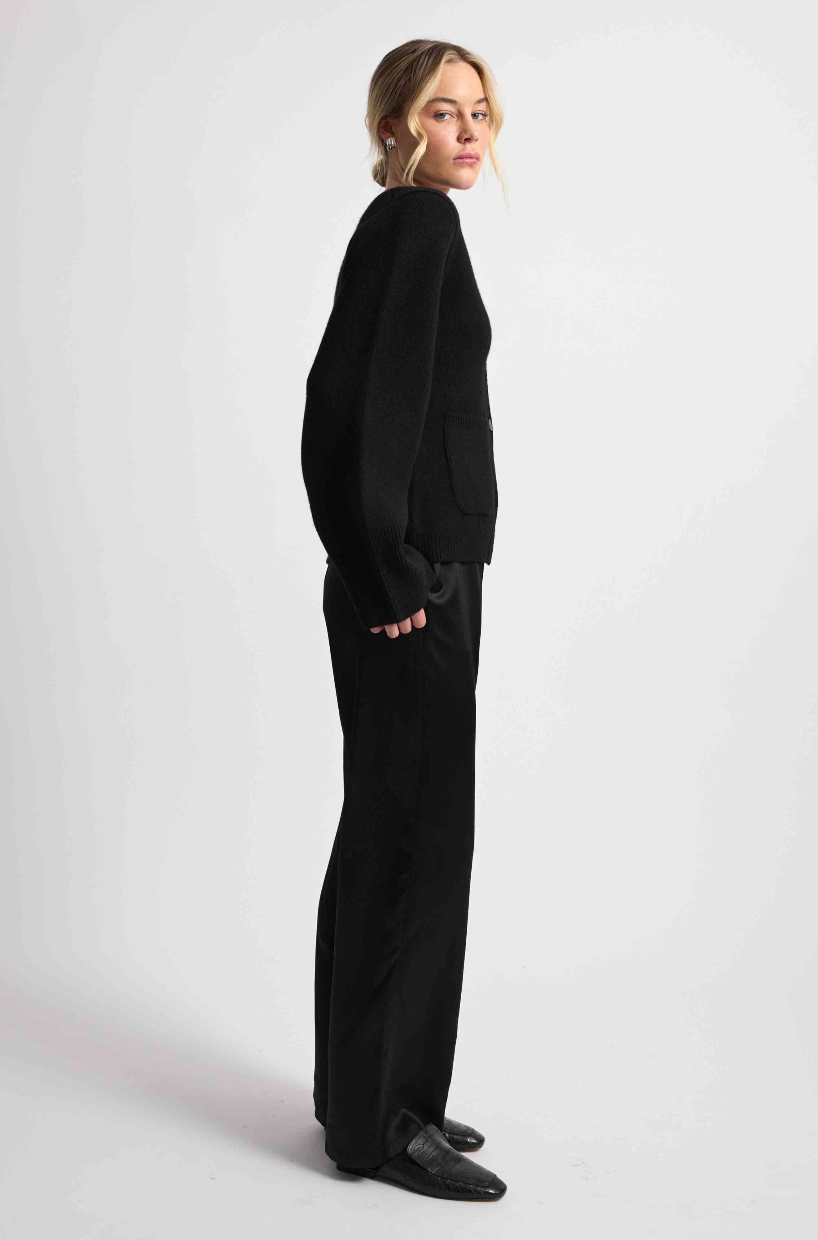Person wearing a black outfit on a white background
