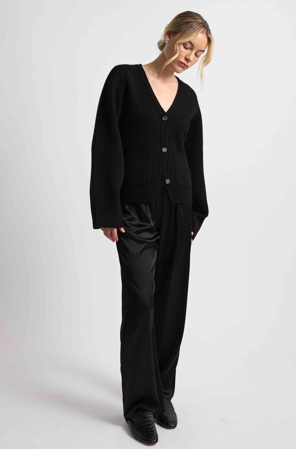 Person wearing a black outfit on a white background