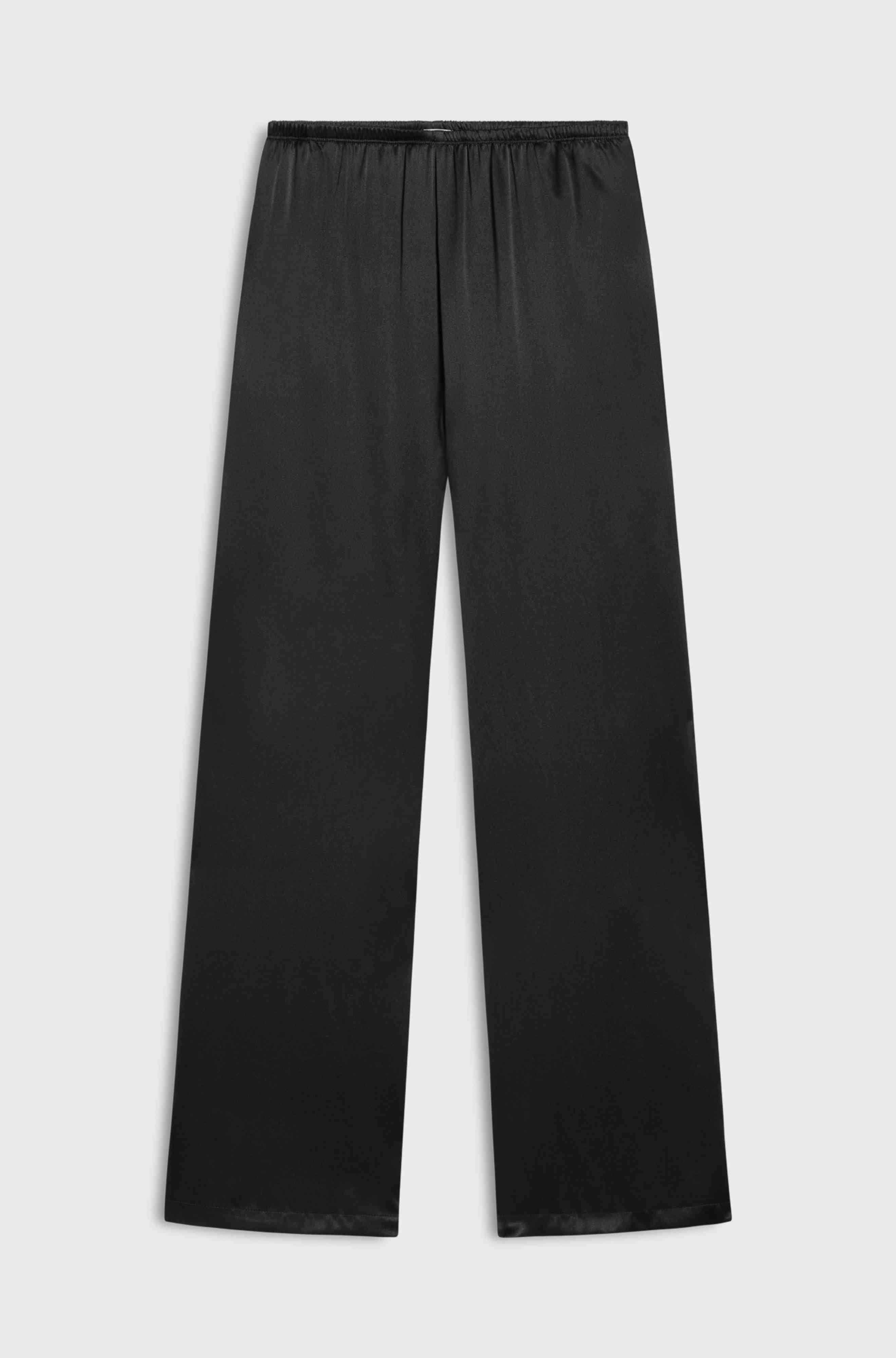 Black silk pants on a light gray background