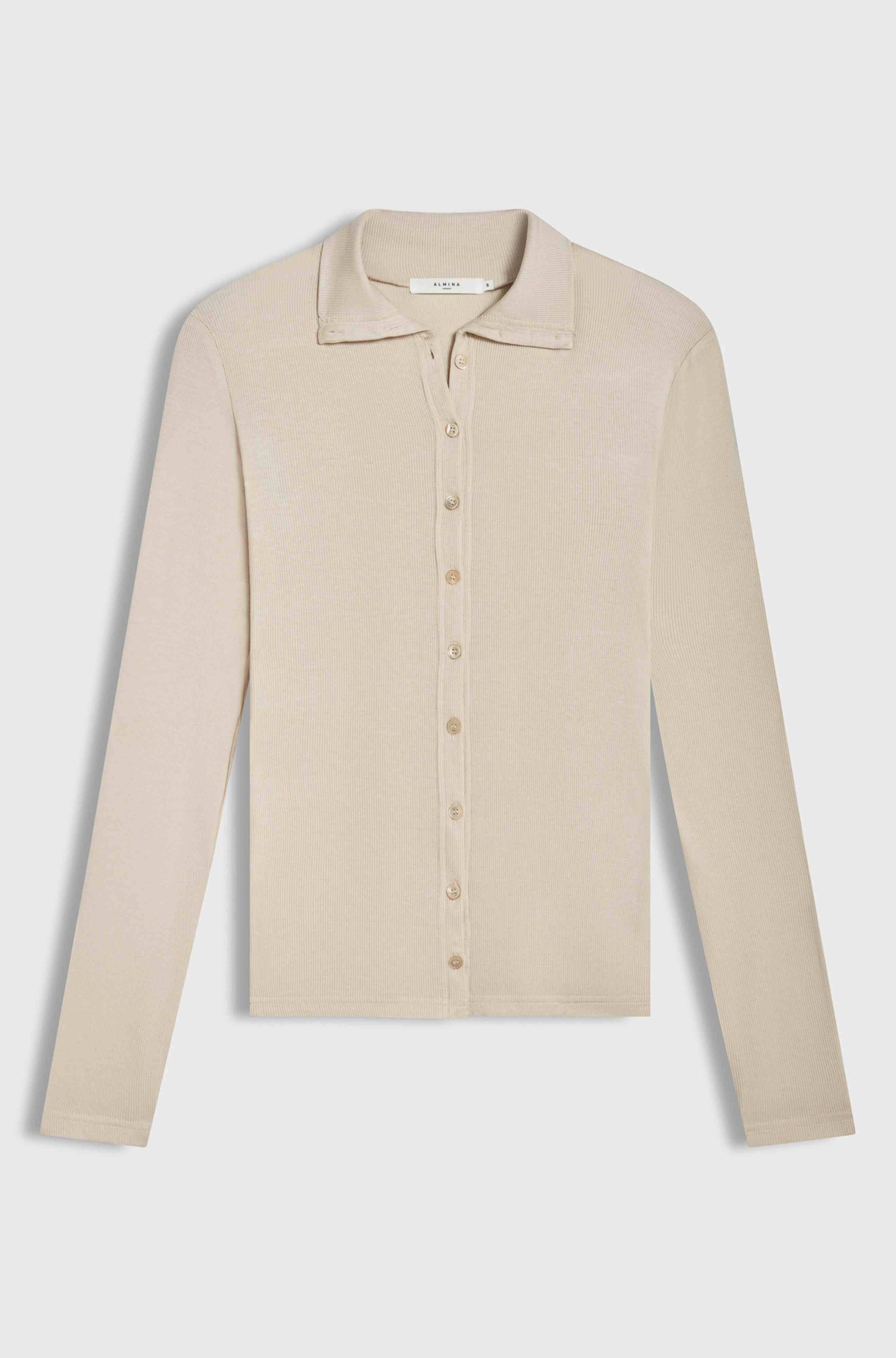 Pink button up shirt on a light grey background