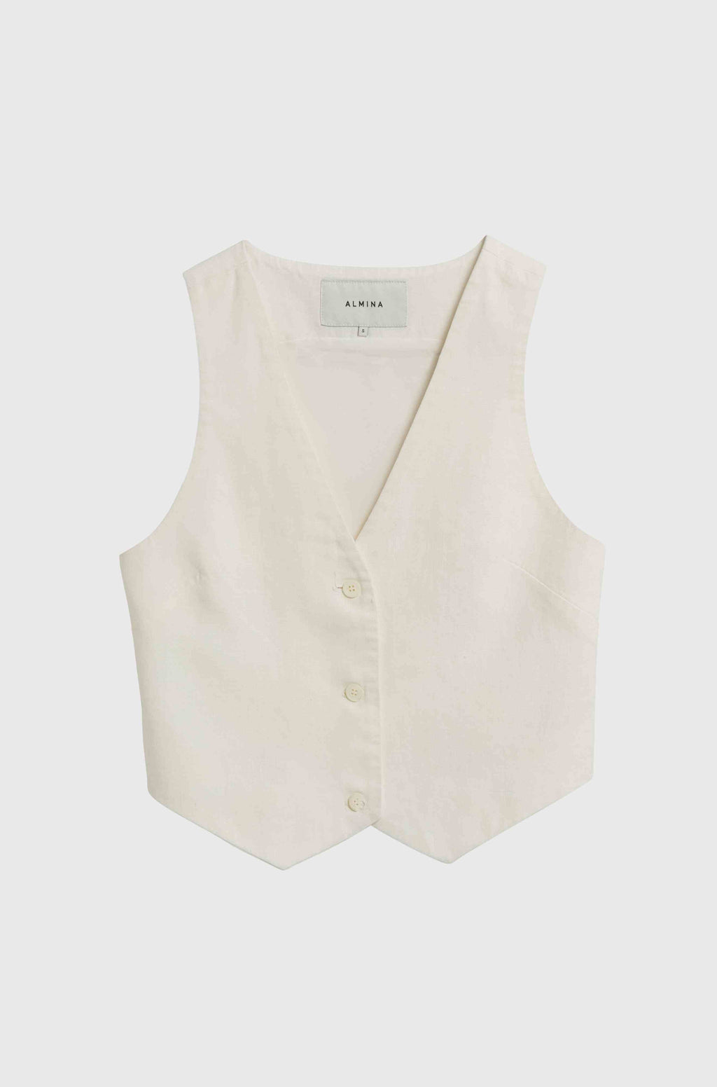 White linen vest against a light grey background