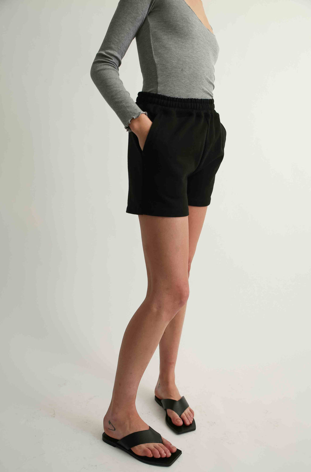 Woman wearing black sweatshorts