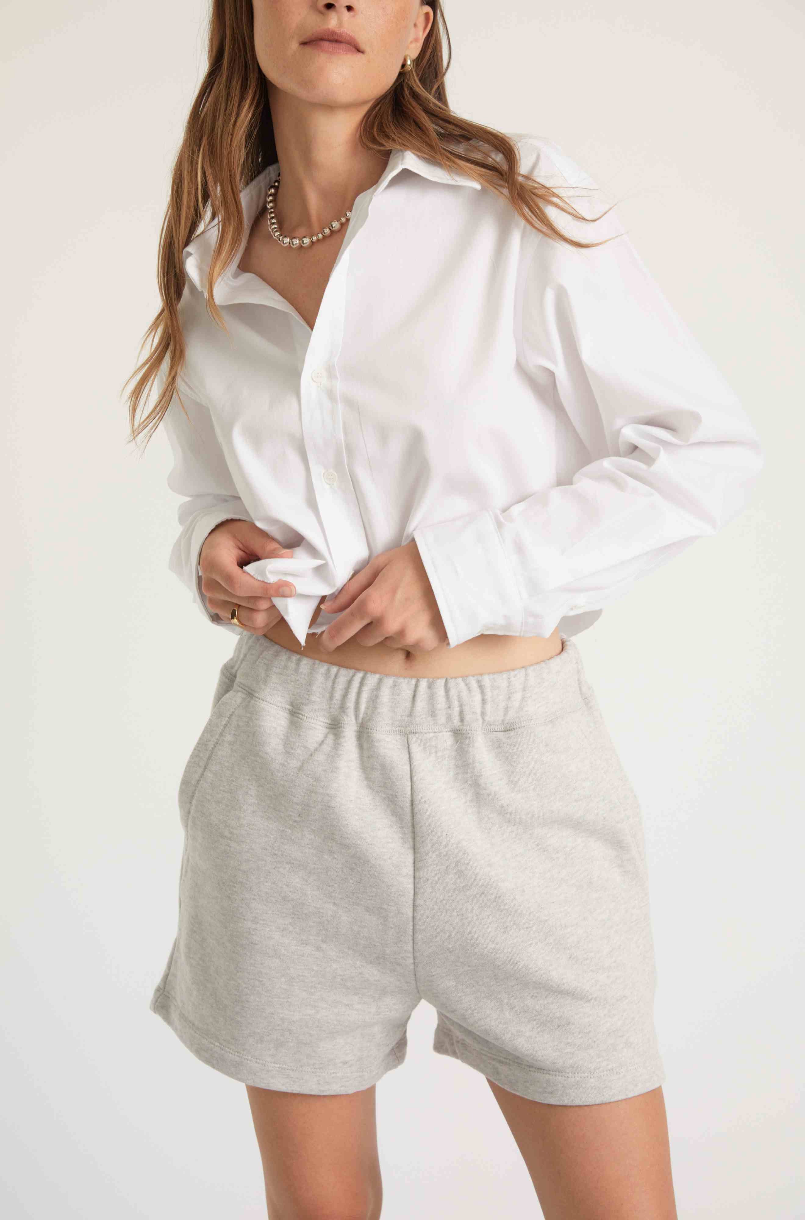 Woman wearing grey sweatshorts