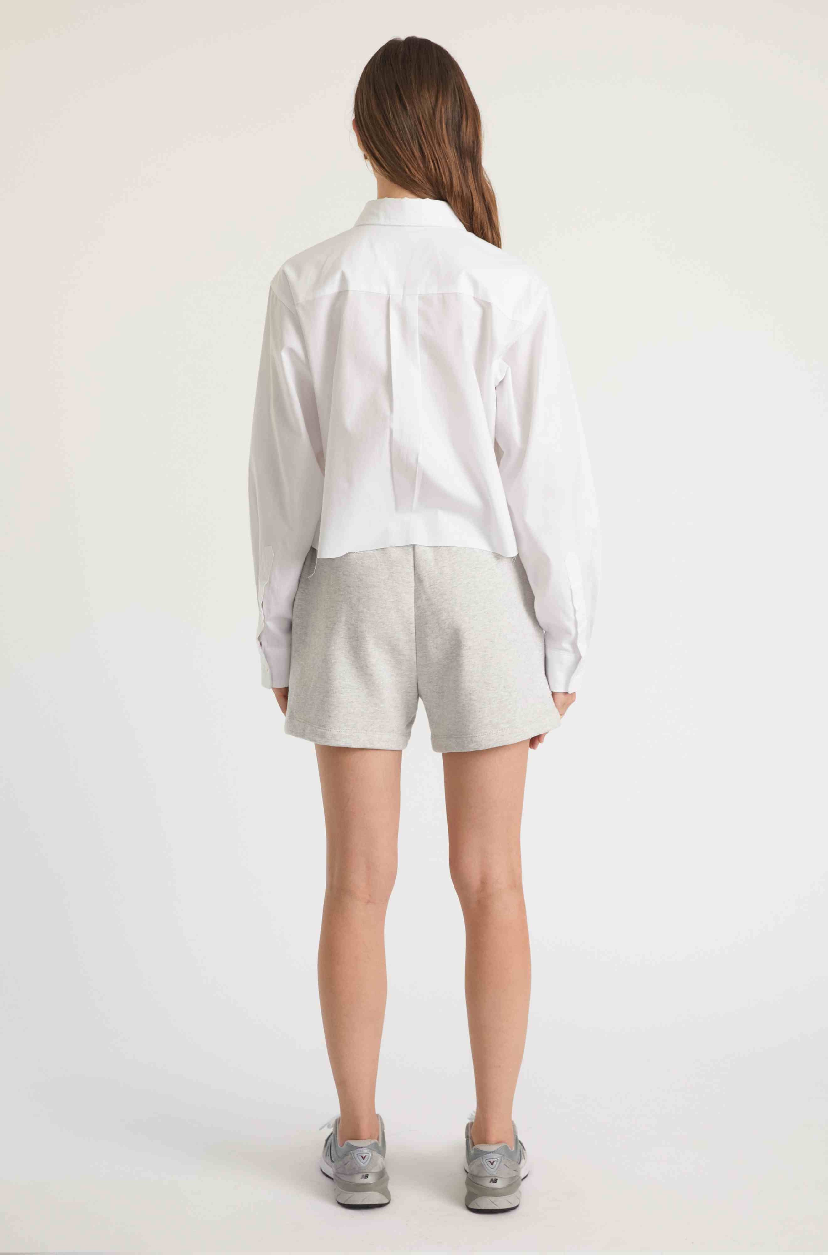 Woman wearing grey sweatshorts