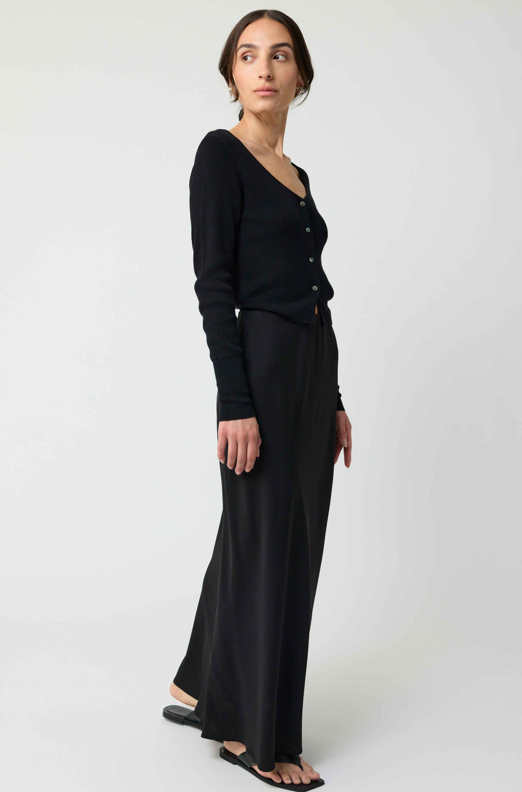 Woman wearing a black outfit on a white background