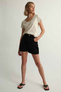 Woman wearing a tee shirt and black shorts