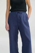Woman wearing blue linen pants with a tie waist