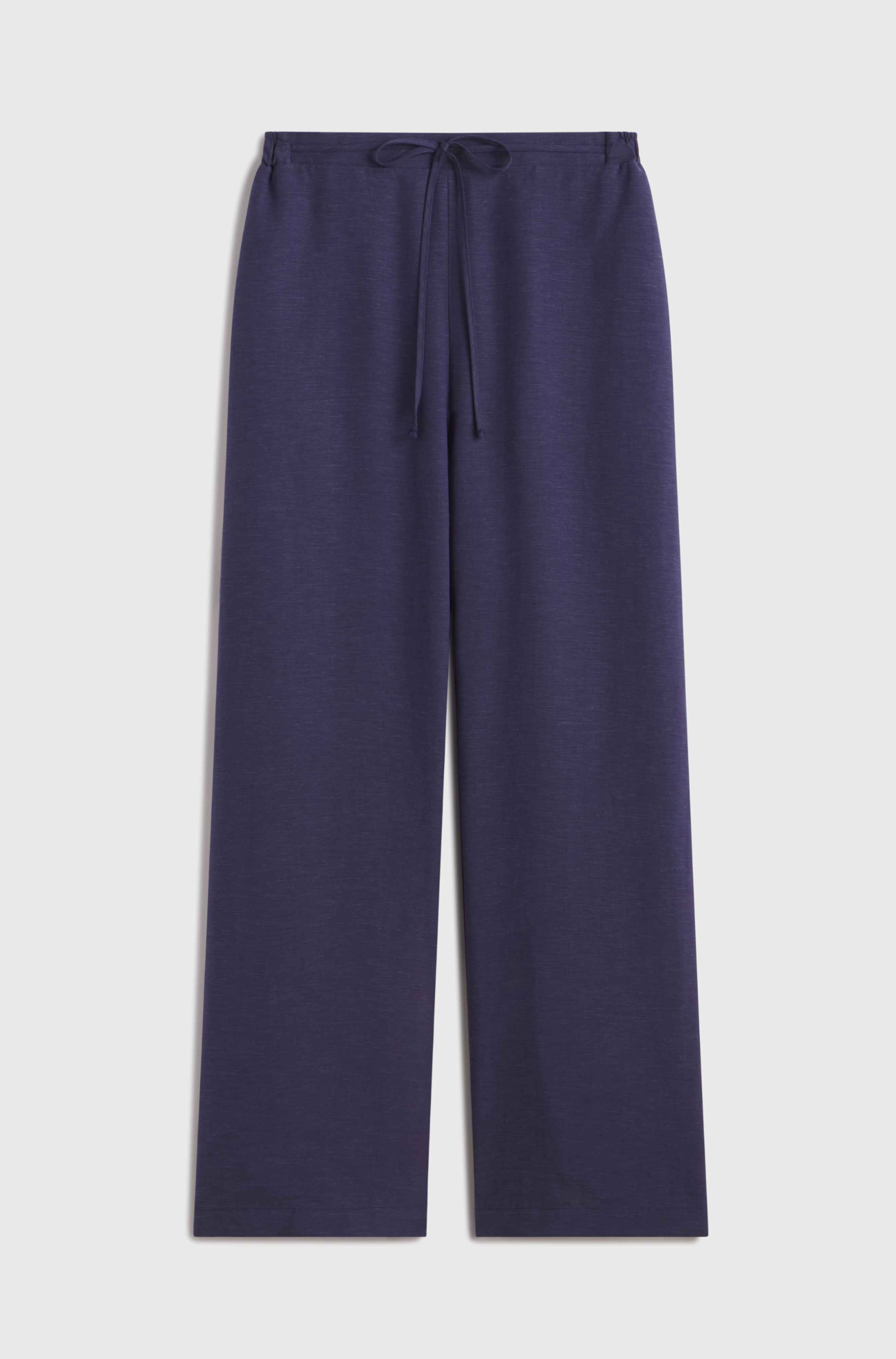 Woman wearing blue linen pants with a tie waist