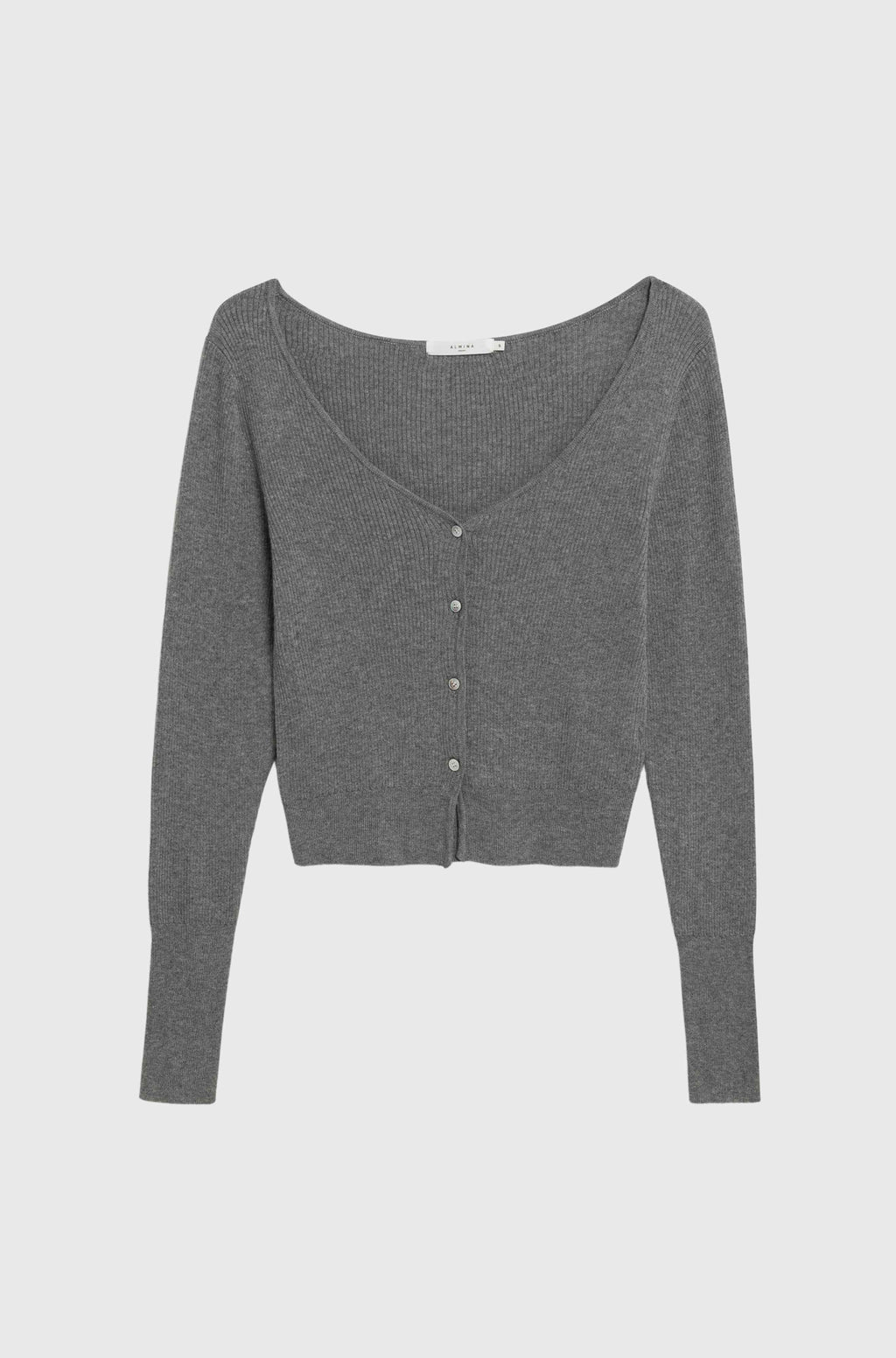 Woman wearing a grey cardigan with grey cargo pants on a light grey background