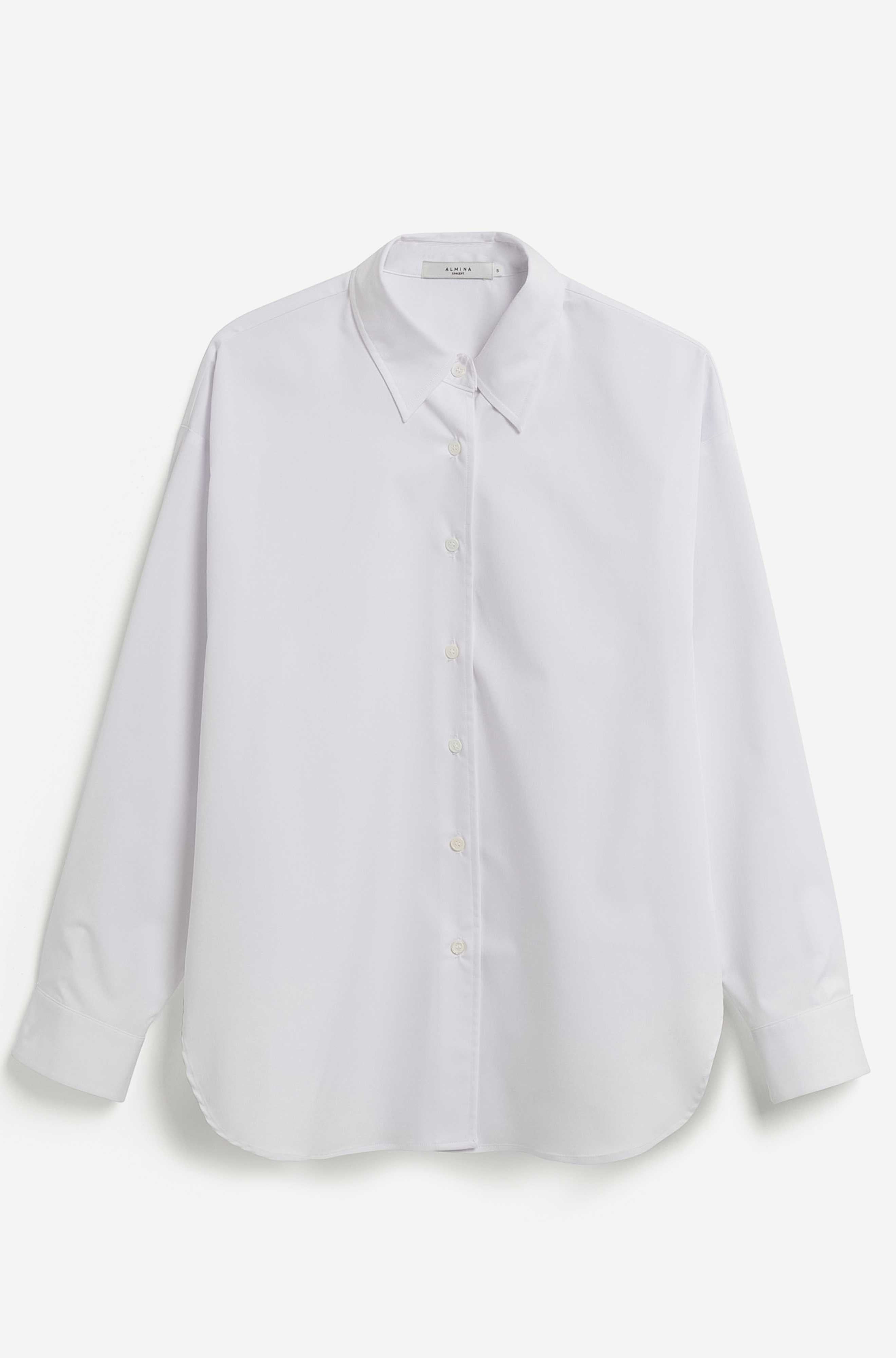 A white long-sleeve button-up shirt with a pointed collar, laid flat against a light off-white background.