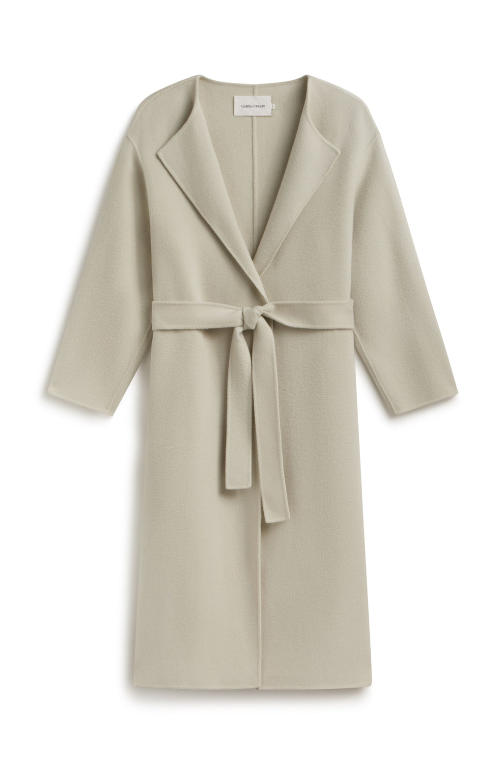A light grey long coat against a light grey wall