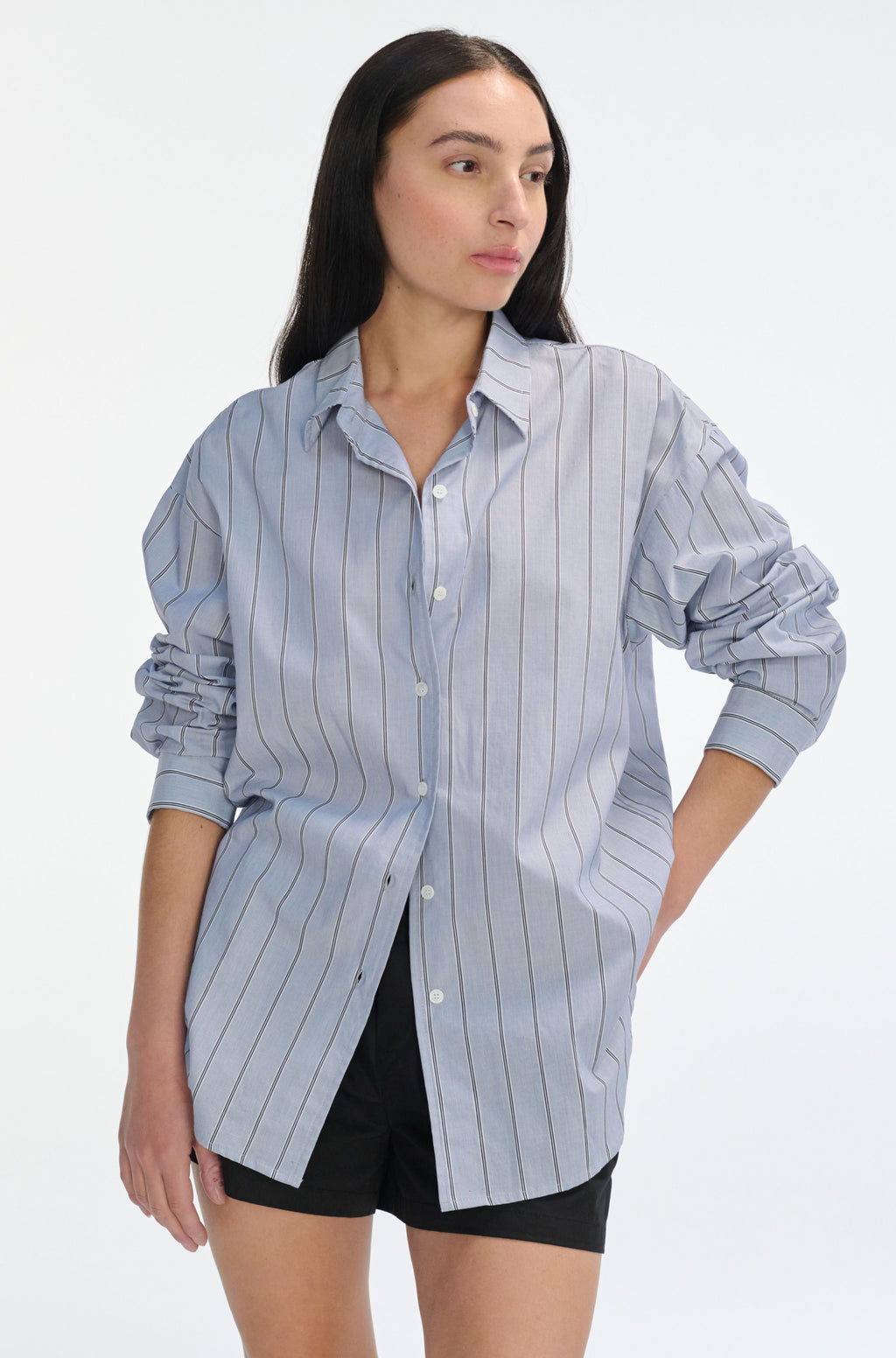 Woman wearing a light blue striped shirt on a white background