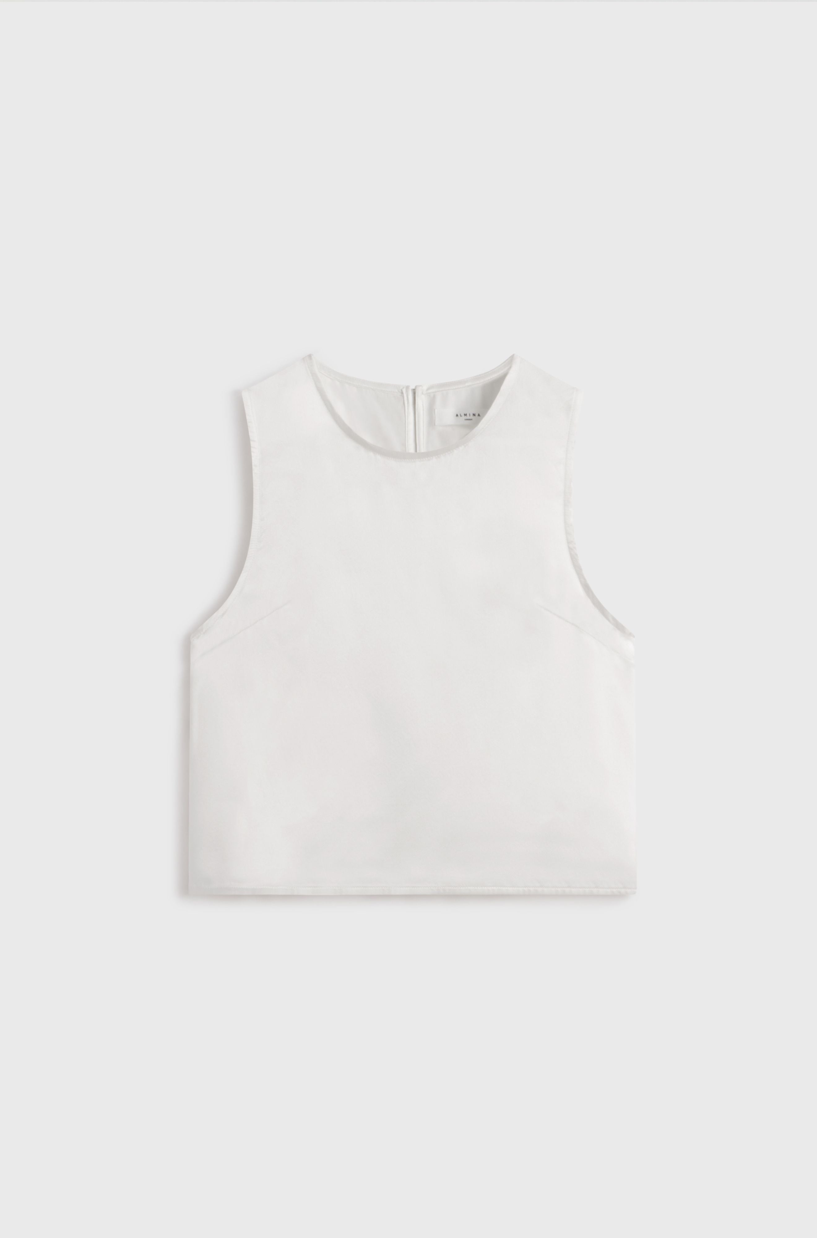 White silk tank top on a light gray background