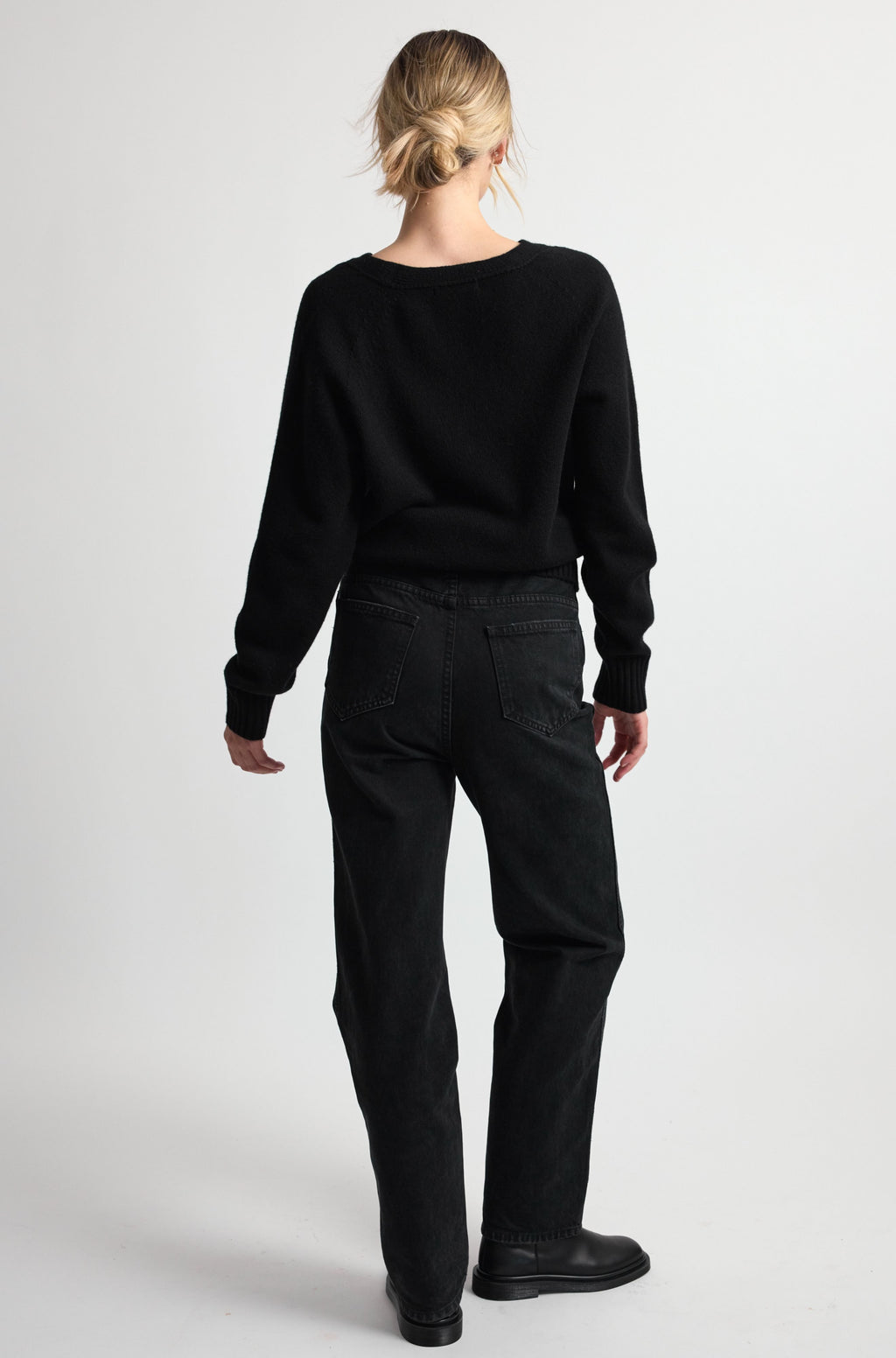 Person wearing a black outfit on a white background