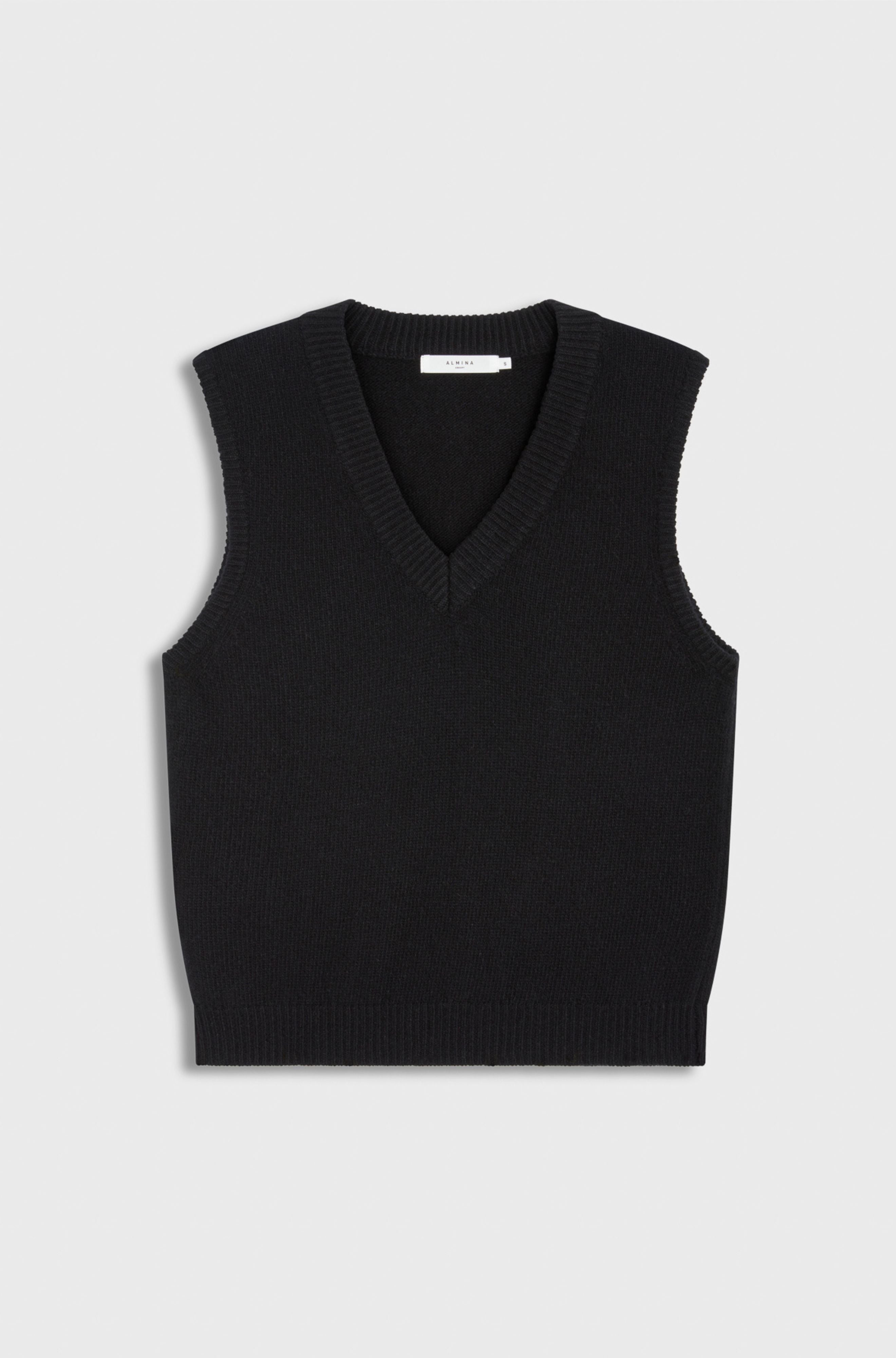 Black sleeveless sweater vest on a light gray background