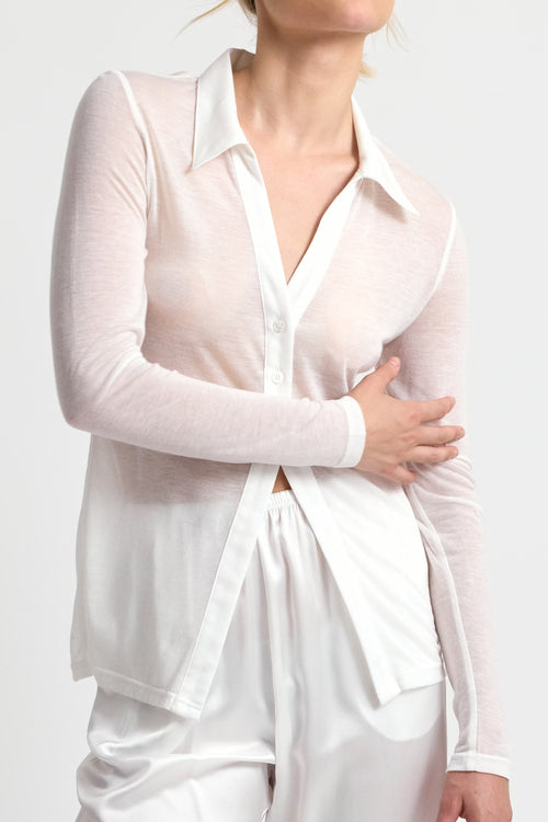 White long-sleeve top worn by a person on a white background