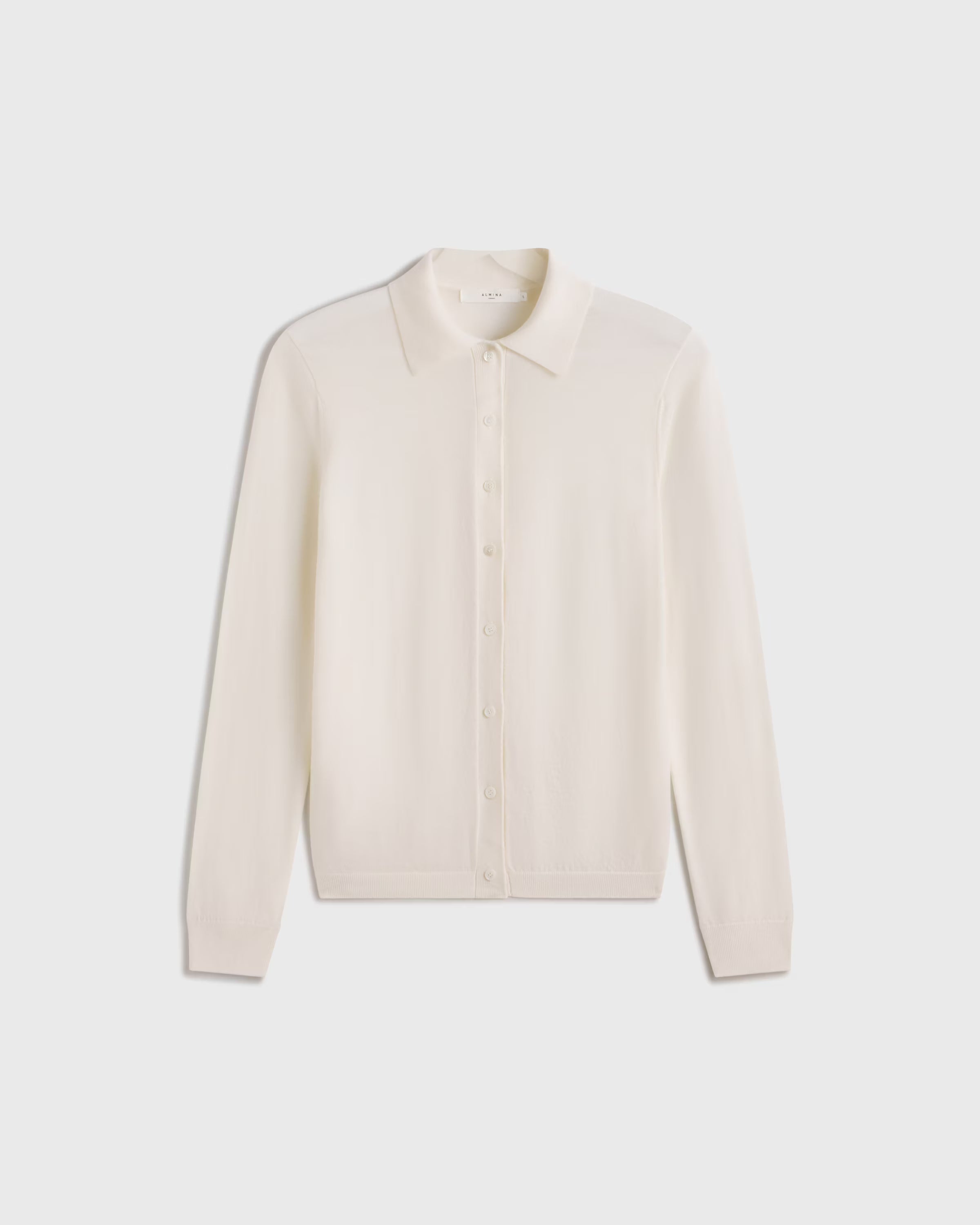 Beige long-sleeve shirt on a light gray background