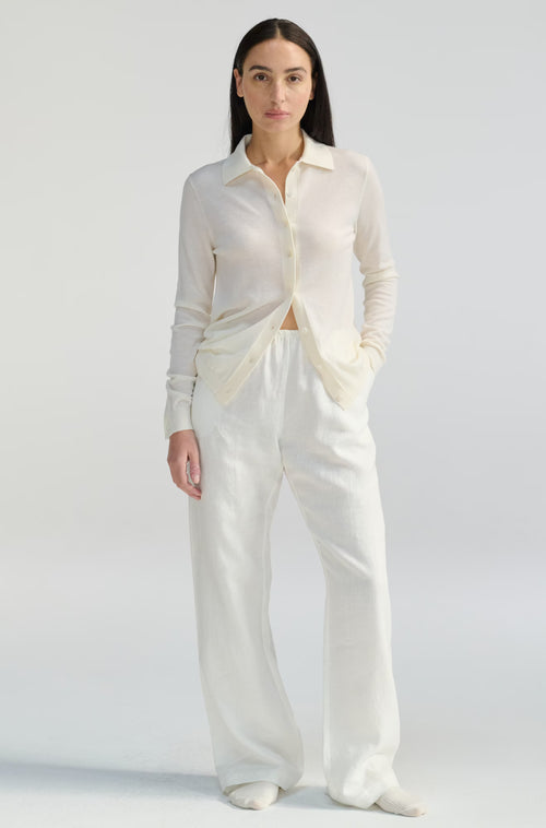 Woman wearing a white outfit on a plain background